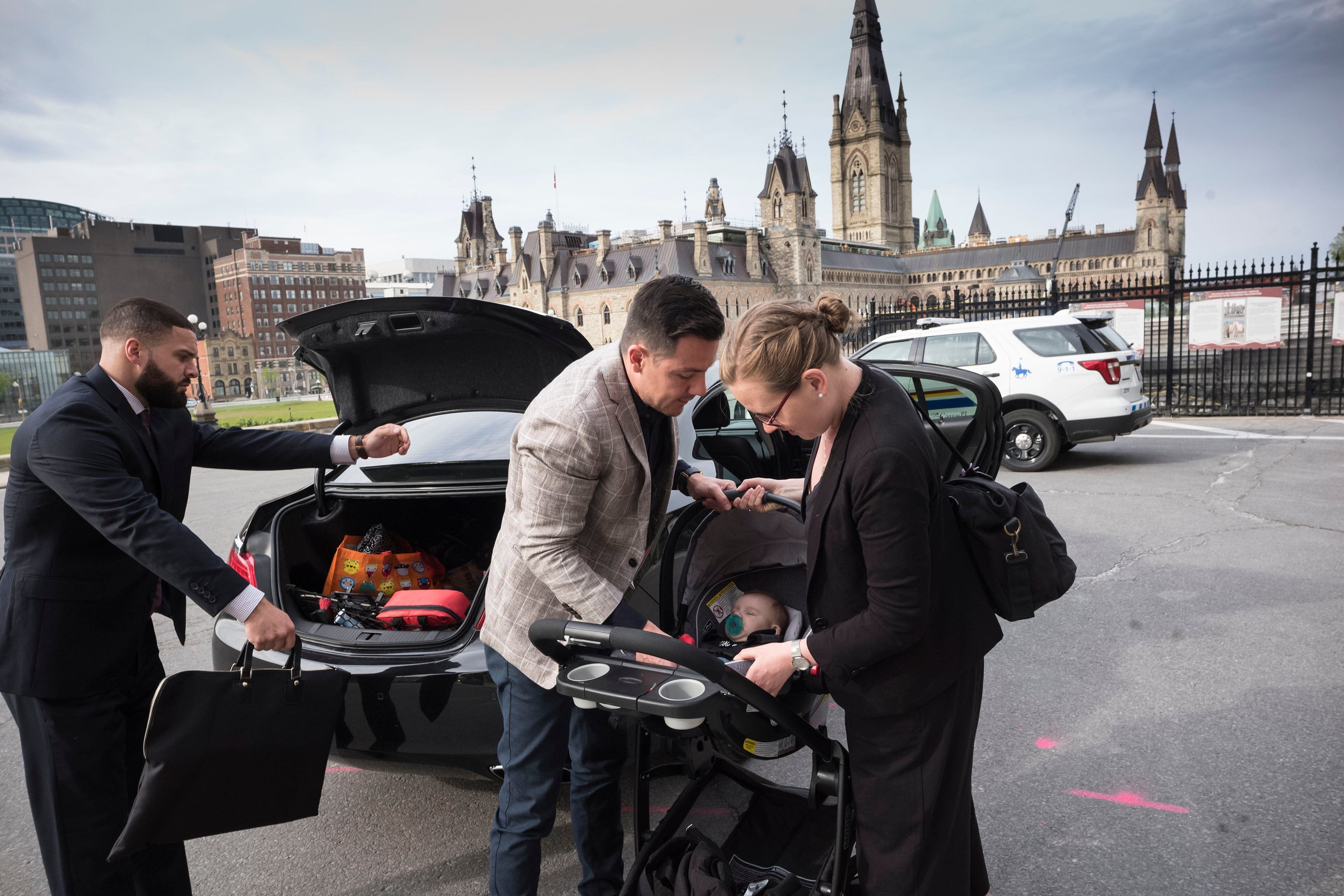 Karina Gould, Minister for Democratic Institutions, with three-month old son Oliver and husband Alberto Gerones on Parliament Hill in Ottawa, May 22, 2018. Gould met with many members of Cabinet and Prime Minister Justin Trudeau in his office. (Photograph by Peter Bregg)