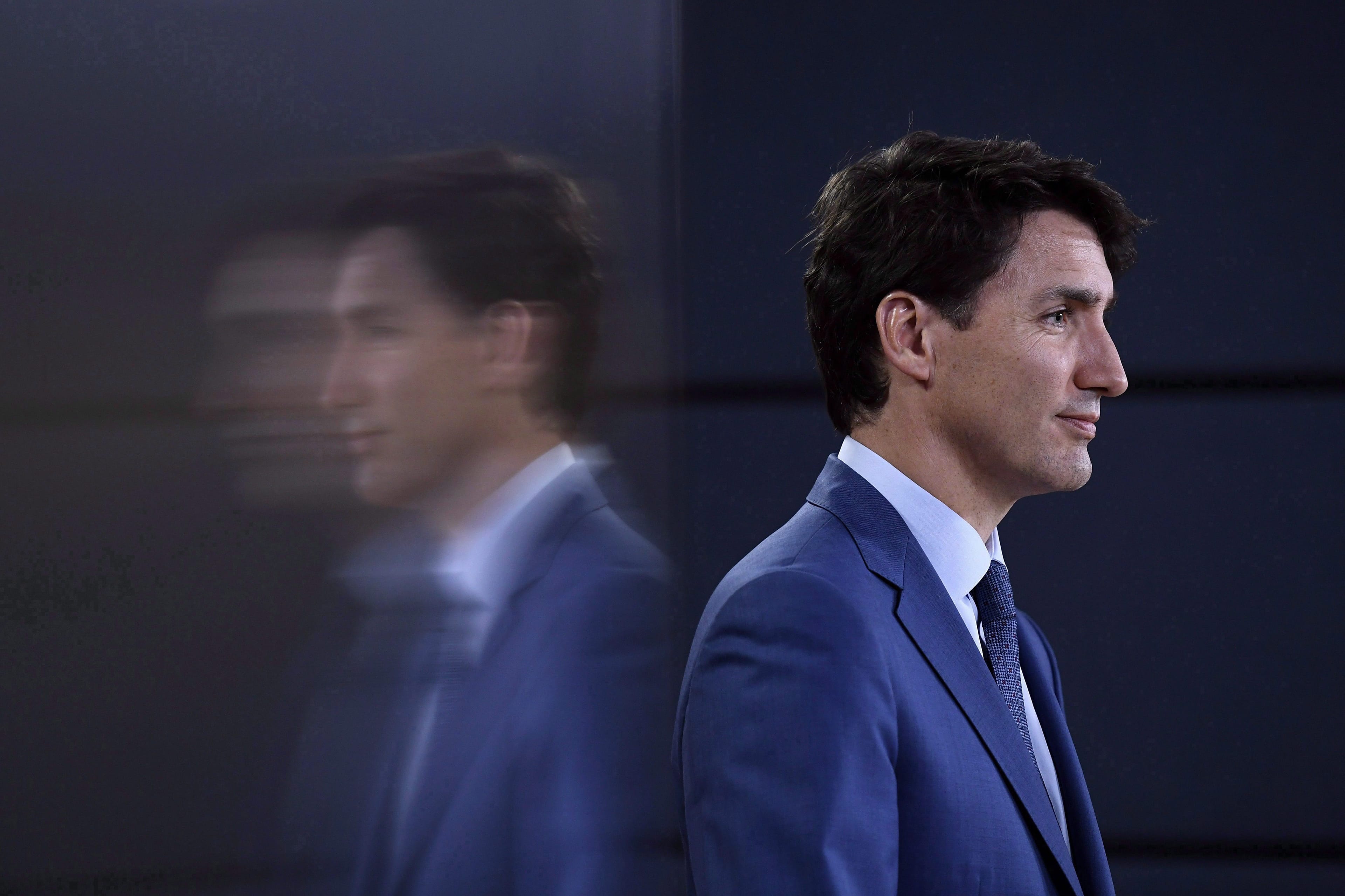 Prime Minister Justin Trudeau is reflected in a TV screen as he speaks at a press conference in Ottawa on June 20, 2018. (THE CANADIAN PRESS/Justin Tang)