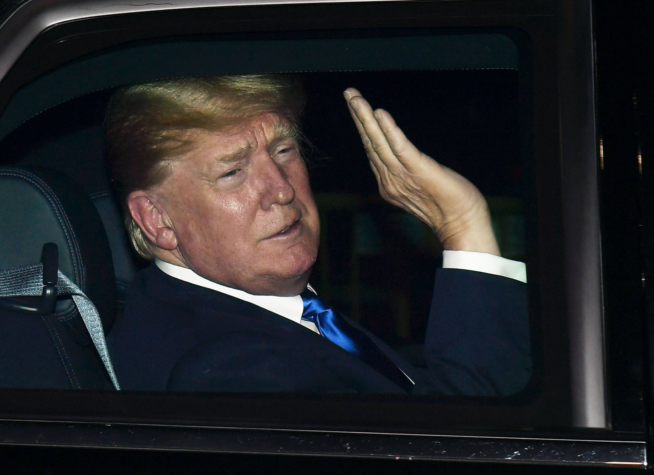 U.S. President Donald Trump waves to the crowd after arriving in Singapore on June 10, 2018. (Photo by Kyodo News via Getty Images)