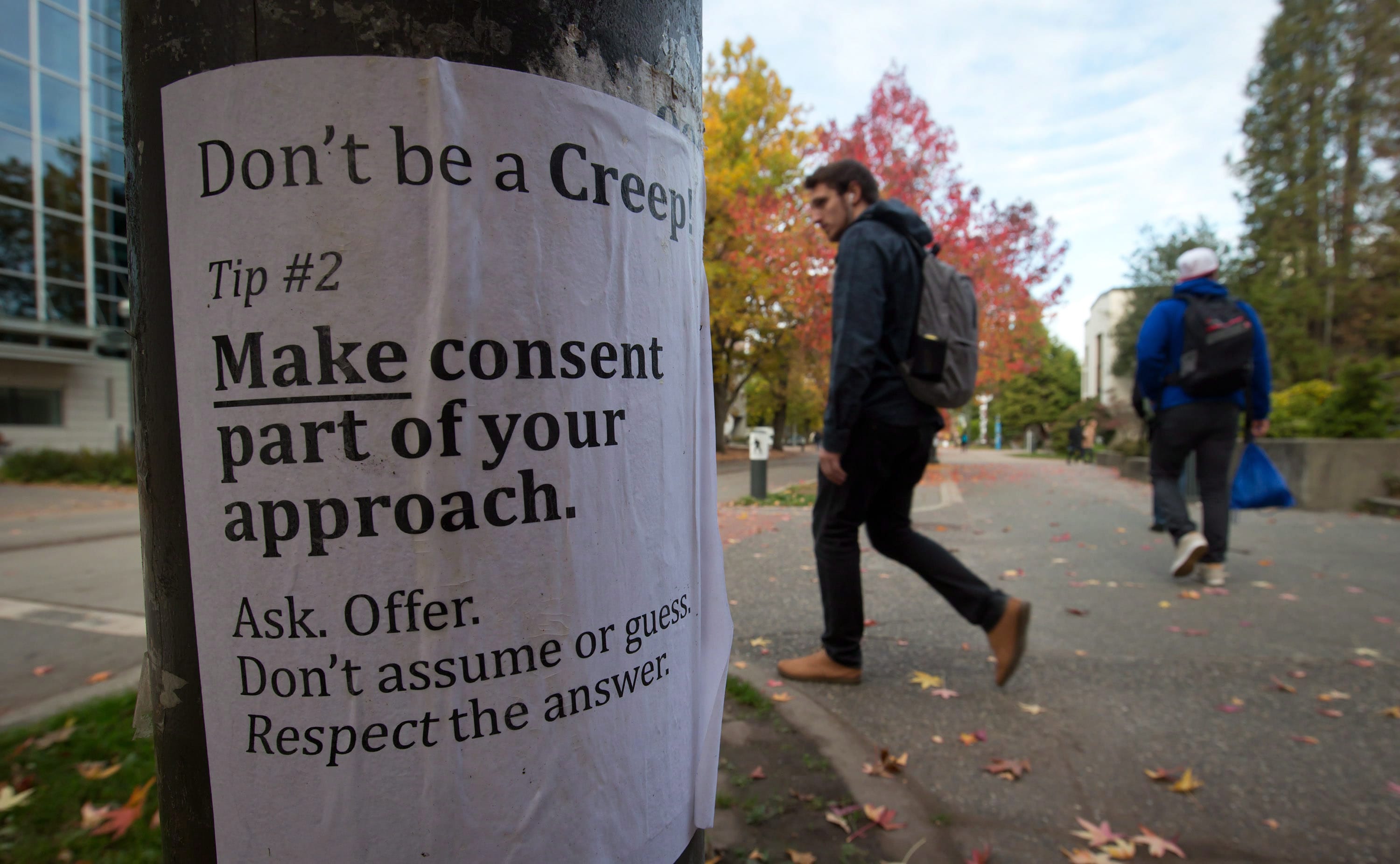 University of British Columbia students walk past a sexual assault poster on the campus in Vancouver, B.C.(Darryl Dyck/CP)