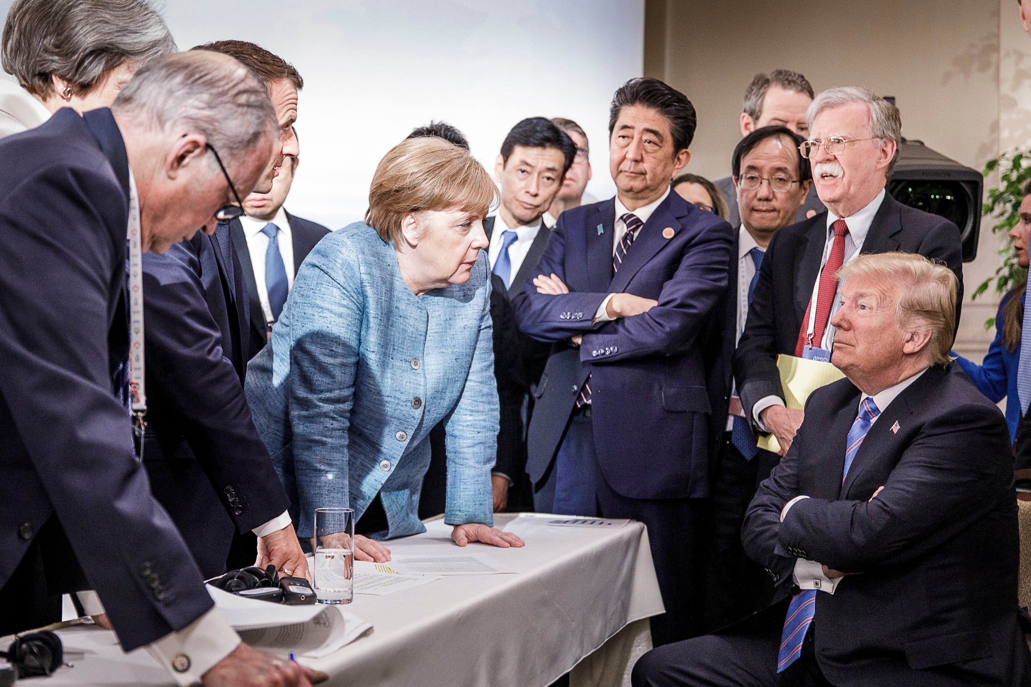 German Chancellor Angela Merkel deliberates with US president Donald Trump on the sidelines of the official agenda on the second day of the G7 summit on June 9, 2018 in Charlevoix, Canada.  (Photo by Jesco Denzel /Bundesregierung via Getty Images)