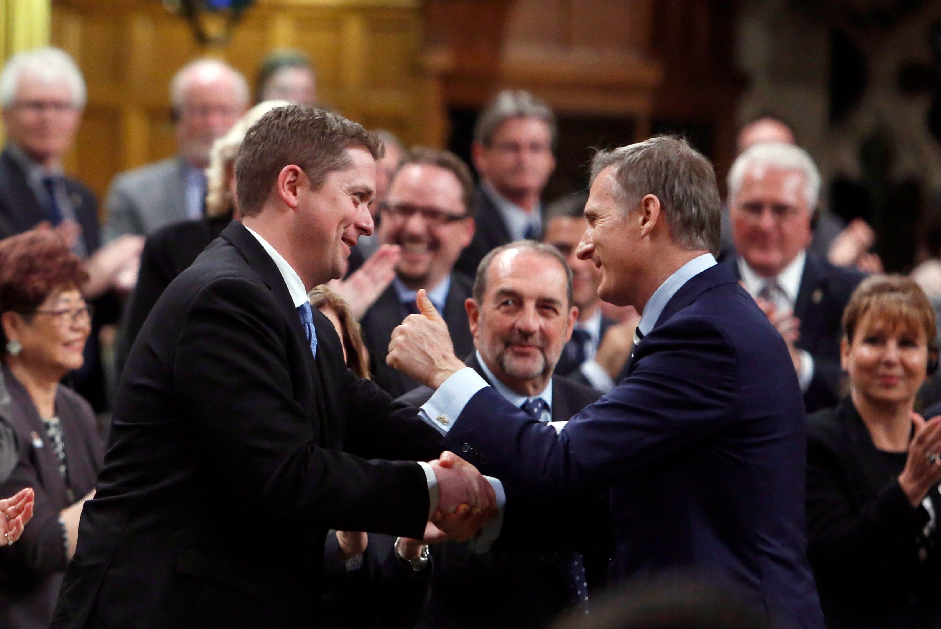 Conservative MP Maxime Bernier(right)gives the thumbs up to Conservative Leader Andrew Scheer in the House of Commons during Question Period on Parliament Hill in Ottawa, Monday, May 29, 2017. THE CANADIAN PRESS/Fred Chartrand