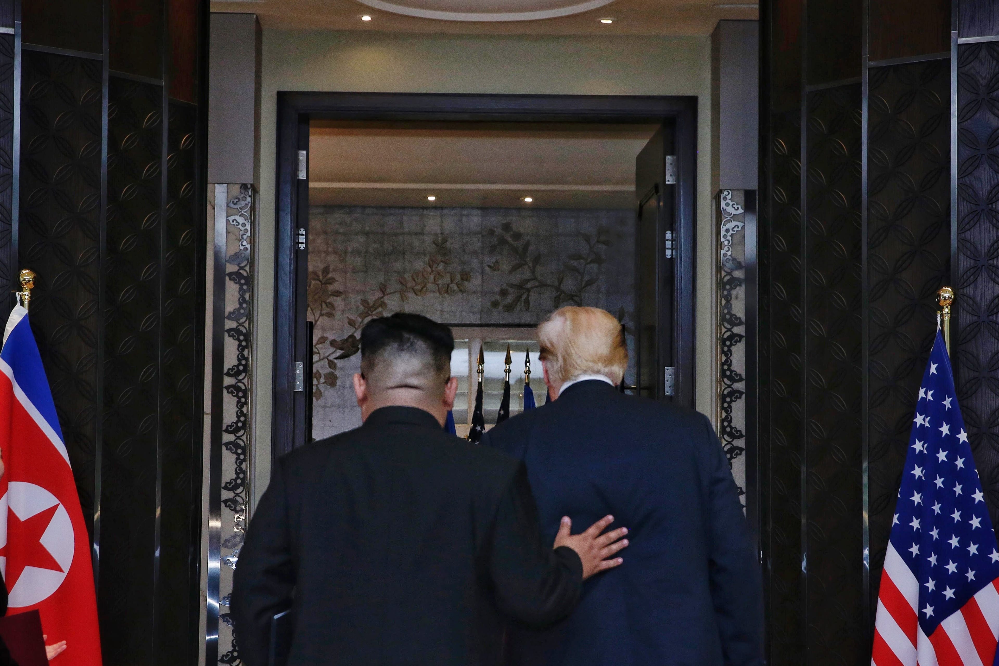 In this handout photograph provided by The Strait Times, North Korean leader Kim Jong-un (L) with U.S. President Donald Trump (R) during their historic U.S.-DPRK summit at the Capella Hotel on Sentosa island on June 12, 2018 in Singapore. (Kevin Lim/The Strait Times/Handout/Getty Images)
