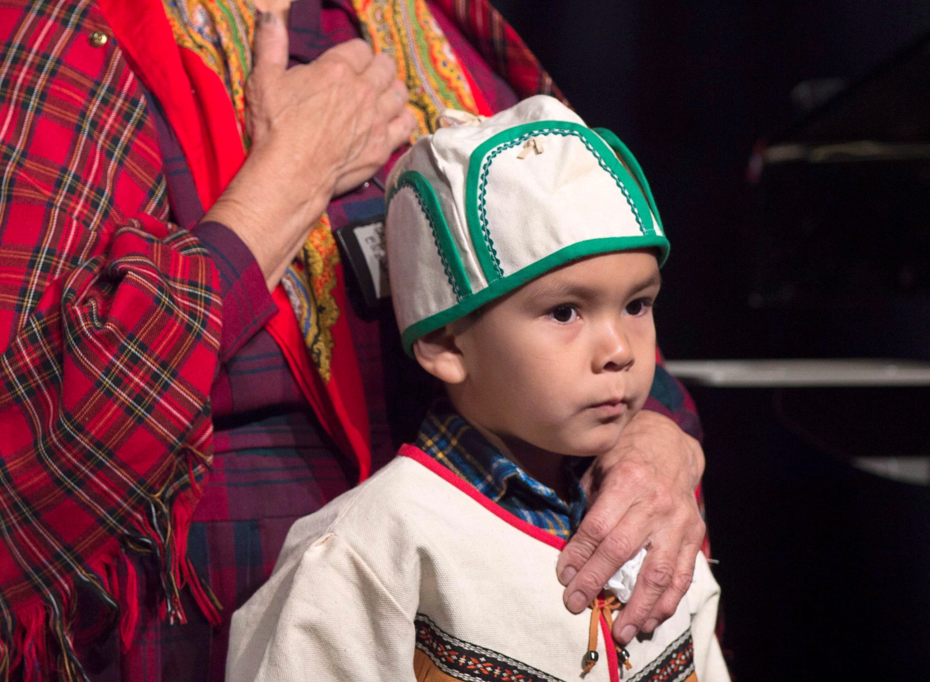 Kanikuen Penashue, 5, from nearby Sheshatshiu, participates in prayers with elders before Prime Minister Justin Trudeau delivered an apology on behalf of the Government of Canada to former students of the Newfoundland and Labrador Residential Schools in Happy Valley-Goose Bay, N.L. on Friday, Nov. 24, 2017. (Andrew Vaughan/CP)