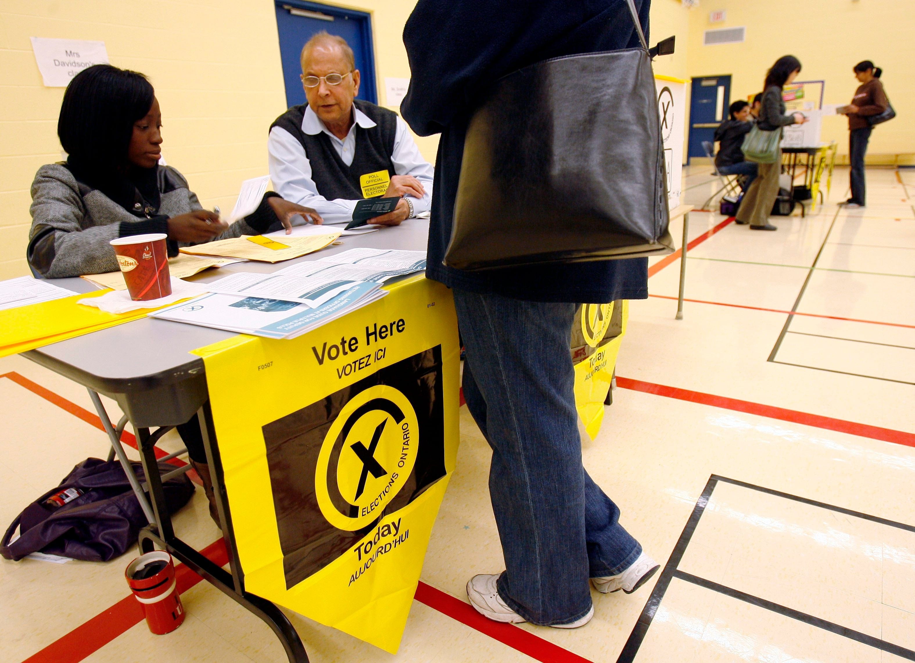 Elections officials man a polling station during the Ontario provincial election at a Mississauga voting station, Wednesday, Oct. 10,  2007. THE CANADIAN PRESS/J.P. Moczulski