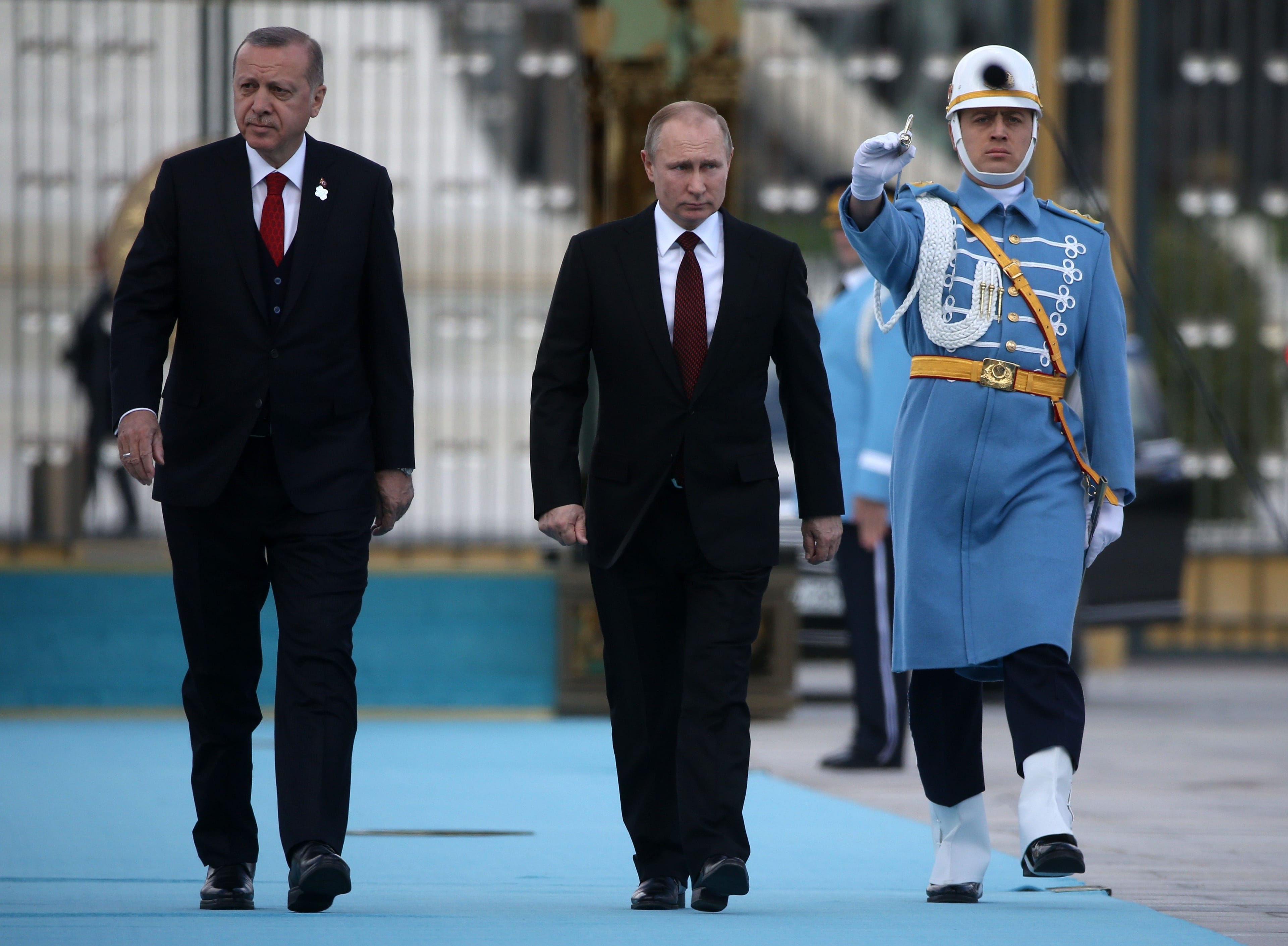 Turkish President Recep Tayyip Erdogan walks with Russian President Vladimir Putin during a welcome ceremony at the presidential palace on April 3, 2018 in Ankara, Turkey. (Photo by Mikhail Svetlov/Getty Images)