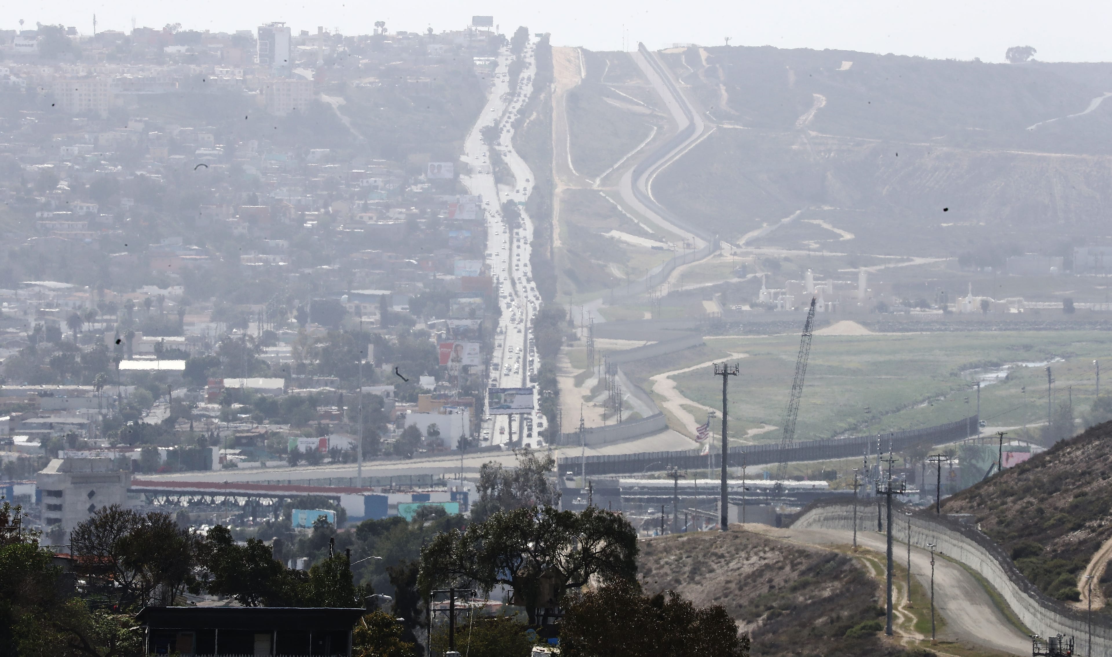 A wall and fencing run along the Mexico (left) and U.S. (right) border on April 6, 2018 as seen from Tijuana, Mexico. (Mario Tama/Getty Images)