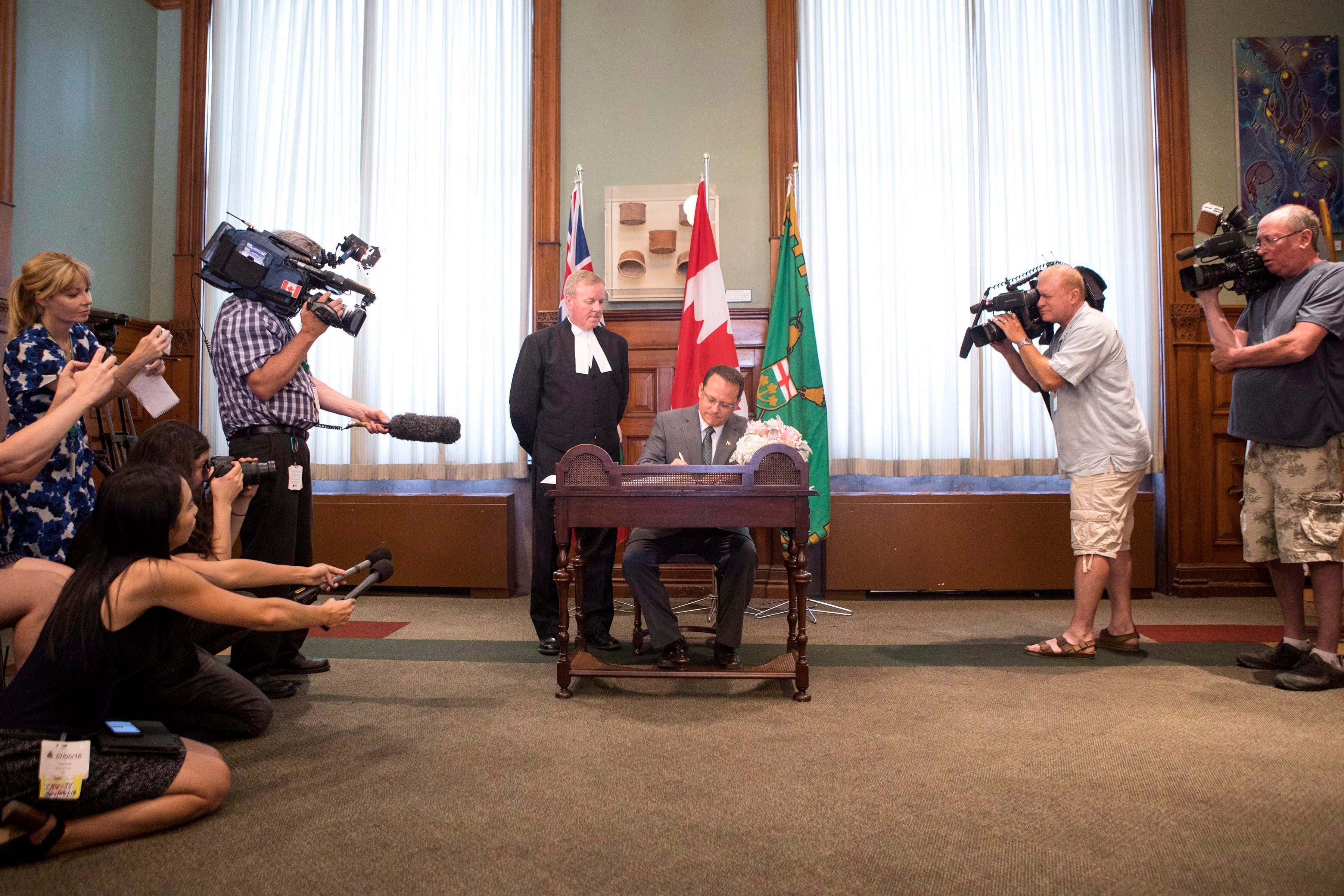 Mike Schreiner, centre right, Leader of the Green Party of Ontario, is sworn in as an MPP during a ceremony at the Ontario Legislature, in Toronto on Thursday, July 5, 2018. THE CANADIAN PRESS/Chris Young