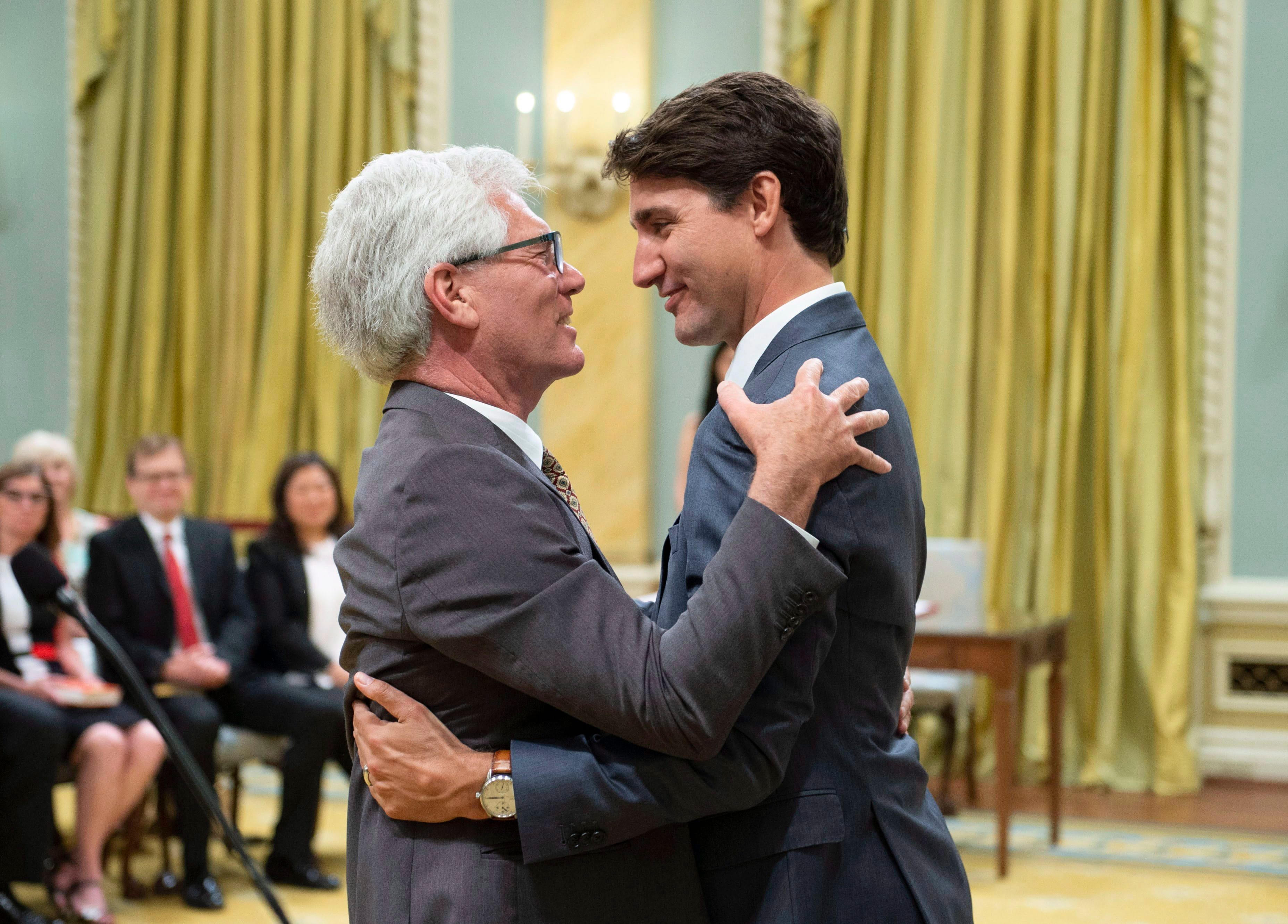 Jim Carr hugs Prime Minister Justin Trudeau after being sworn in as Minister of International Trade Diversification during a ceremony at Rideau Hall in Ottawa on Wednesday, July 18, 2018. THE CANADIAN PRESS/Justin Tang