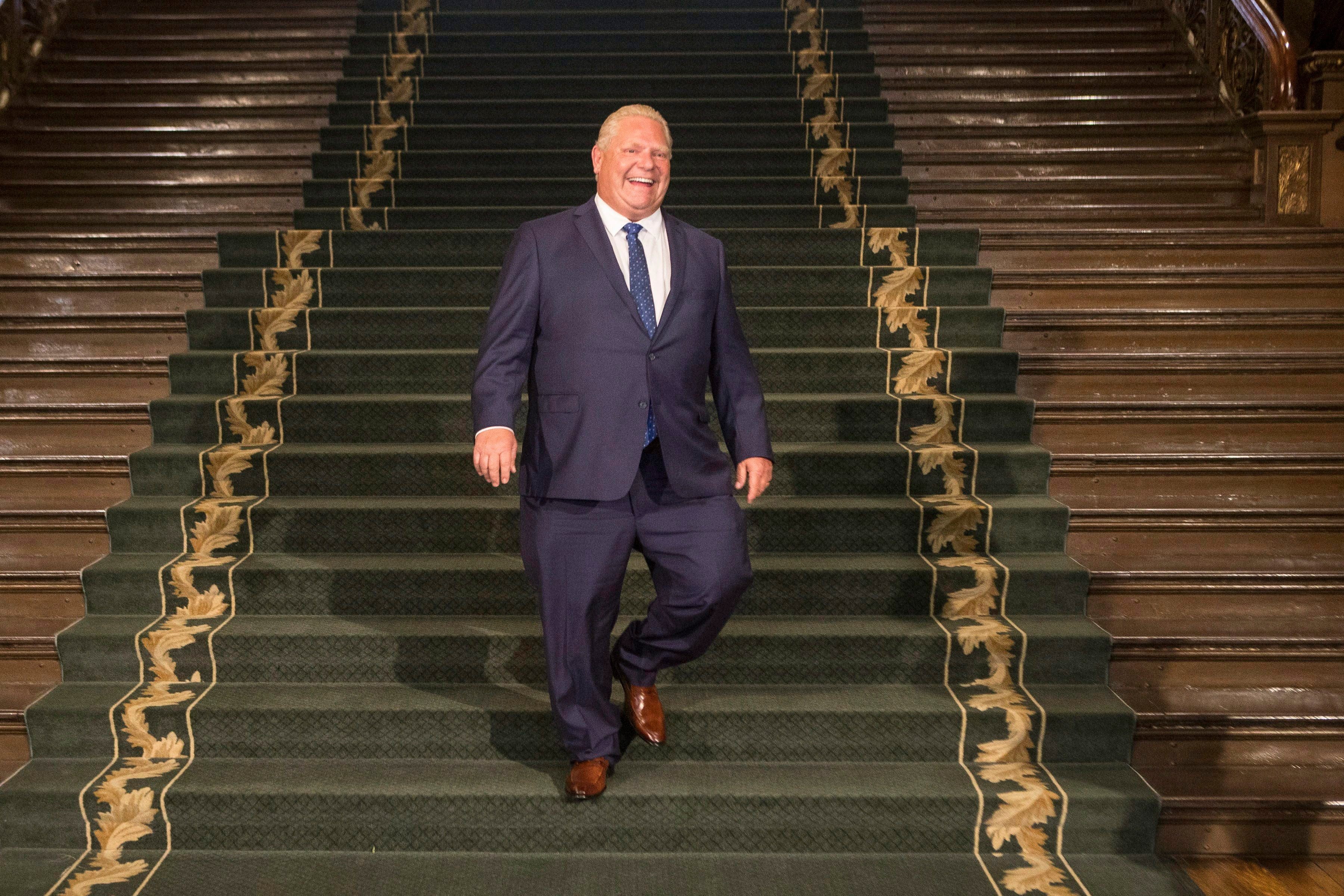 Ontario Premier Doug Ford walks down the grand staircase as he waits for Prime Minister Justin Trudeau at the Ontario Legislature, in Toronto on Thursday, July 5, 2018. THE CANADIAN PRESS/Chris Young