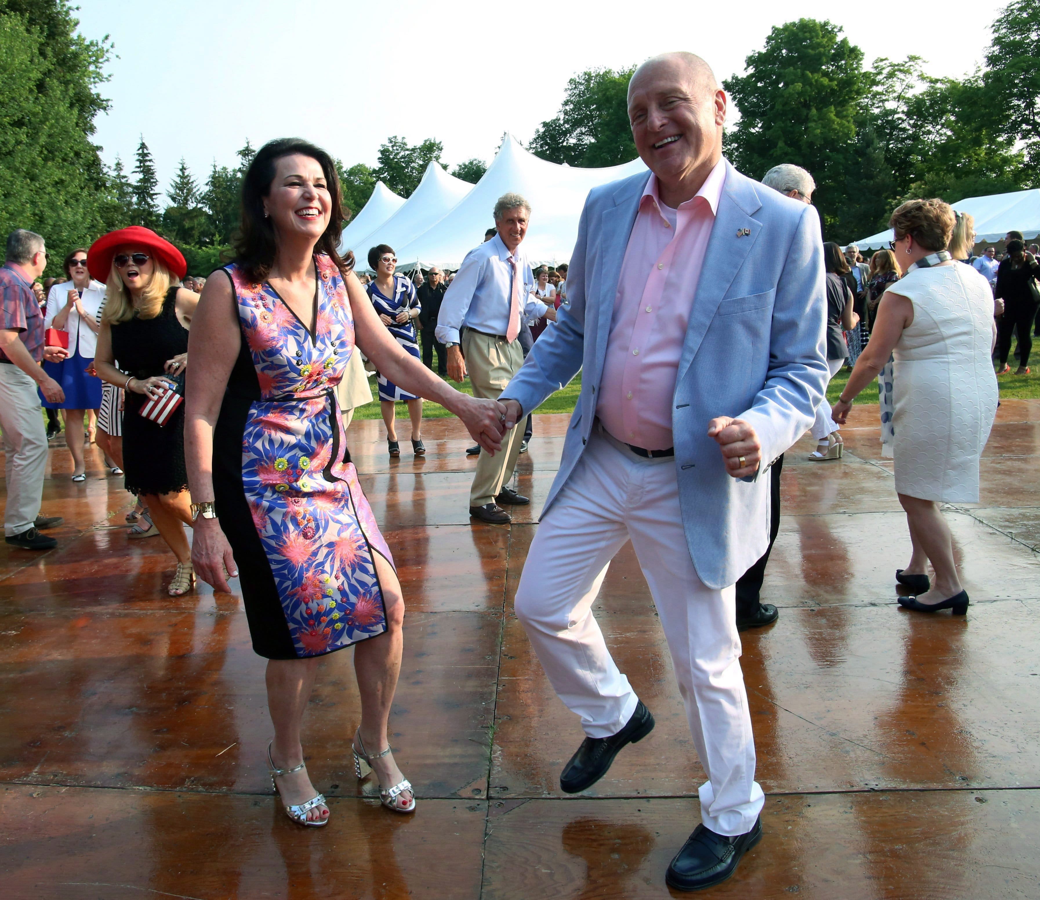 United States ambassador to Canada Bruce Heyman (centre) and wife Vicki (left) dance with guest at the U.S. ambassador's official residence in Ottawa, as they take part in July 4th celebrations, on Sat. July 4, 2015. (Fred Chartrand/CP)