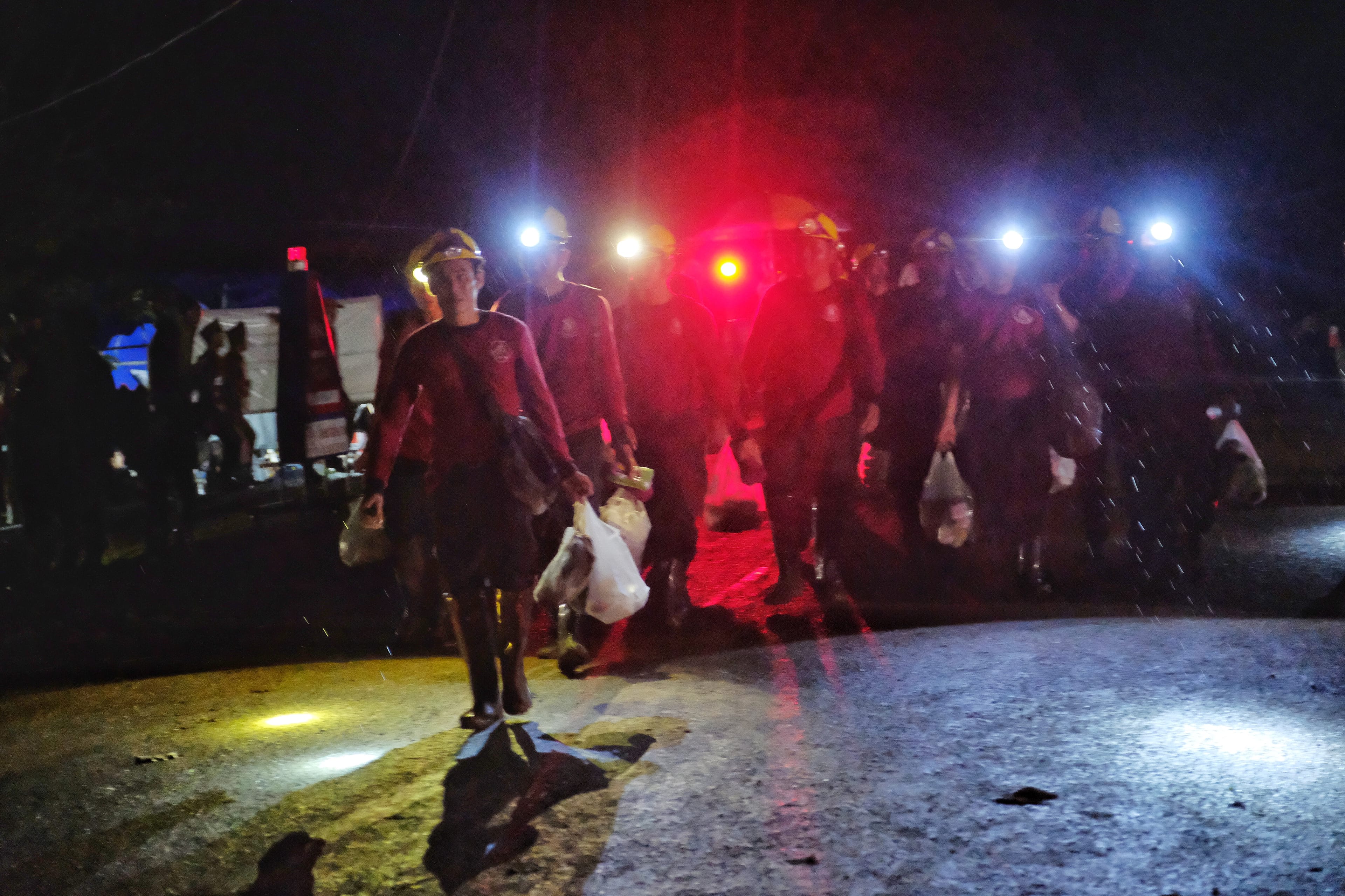 CHIANG RAI, THAILAND - JULY 8: Military personnels, rescue workers and volunteers head out from Tham Luang Nang Non cave after ambulances transported a group of boys rescued from the cave. (Photo by Linh Pham/Getty Images)
