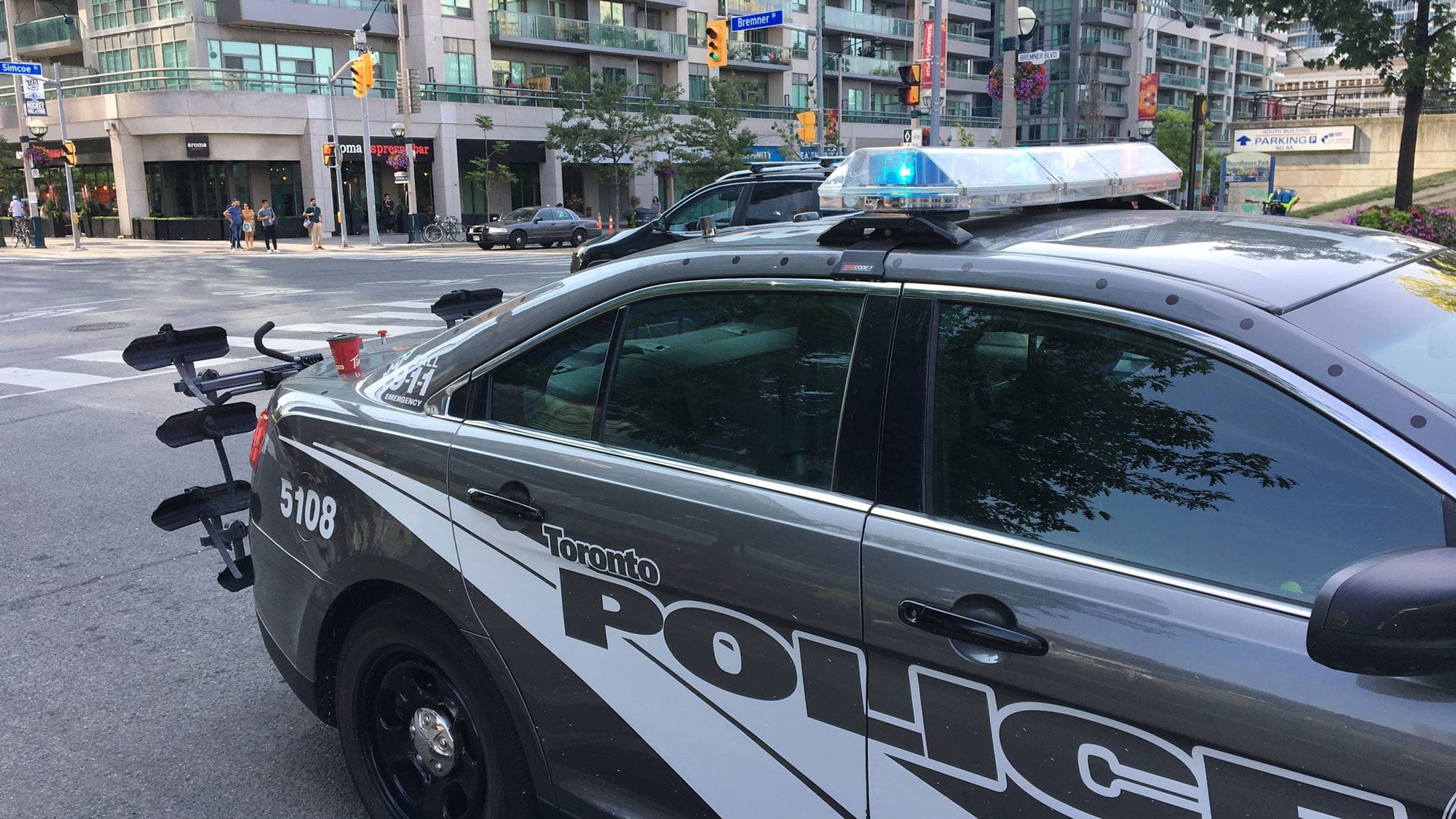 Several police officers patrol the area of Bremner Boulevard and Simcoe Street on July 12, 2018. CITYNEWS/Tony Fera