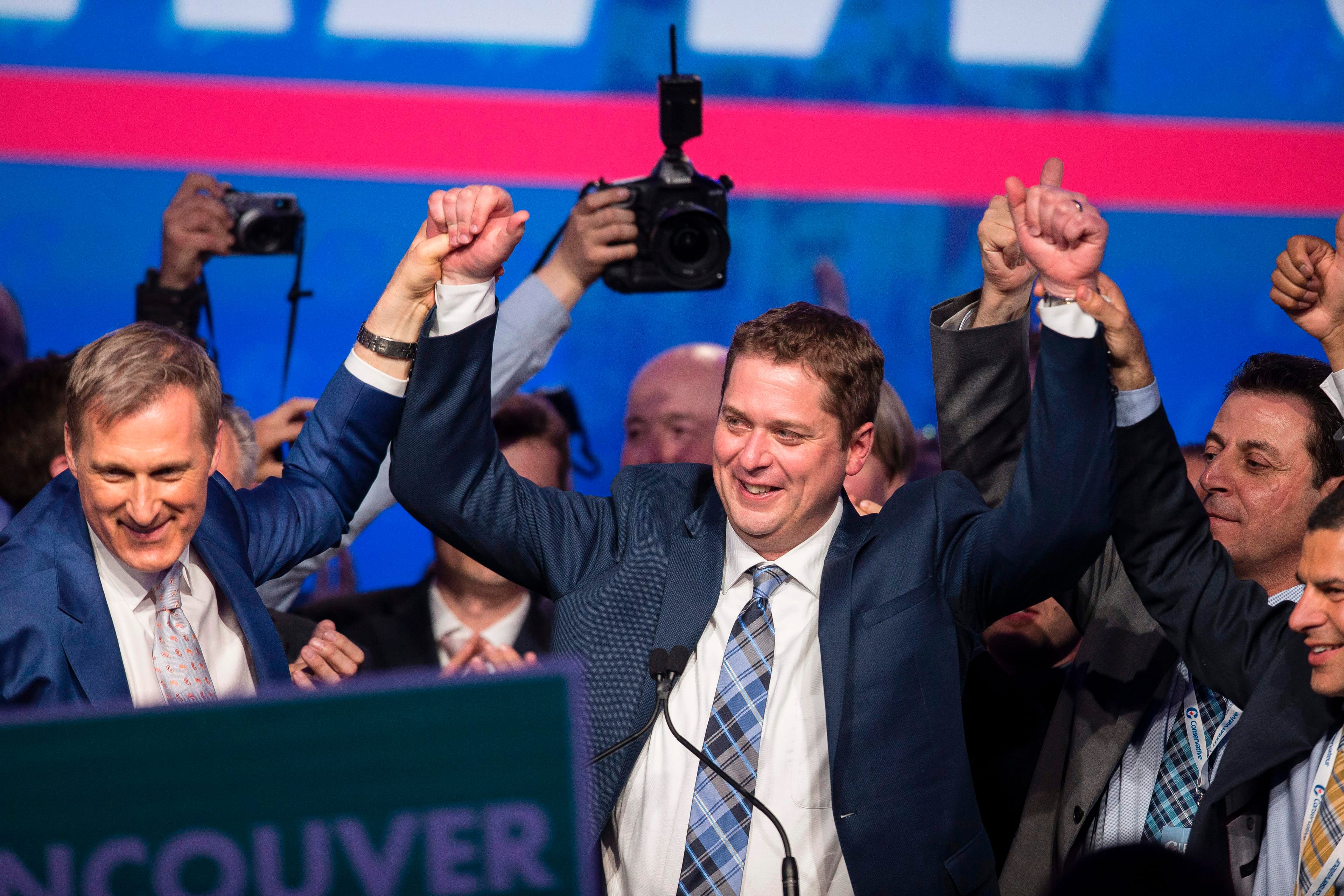 Andrew Scheer, who had just been elected as leader of the Conservative Party of Canada, celebrates with his rival Maxime Bernier (left) at the party's convention in Toronto, Ontario, May 27, 2017. (Geoff Robins/Getty Images)