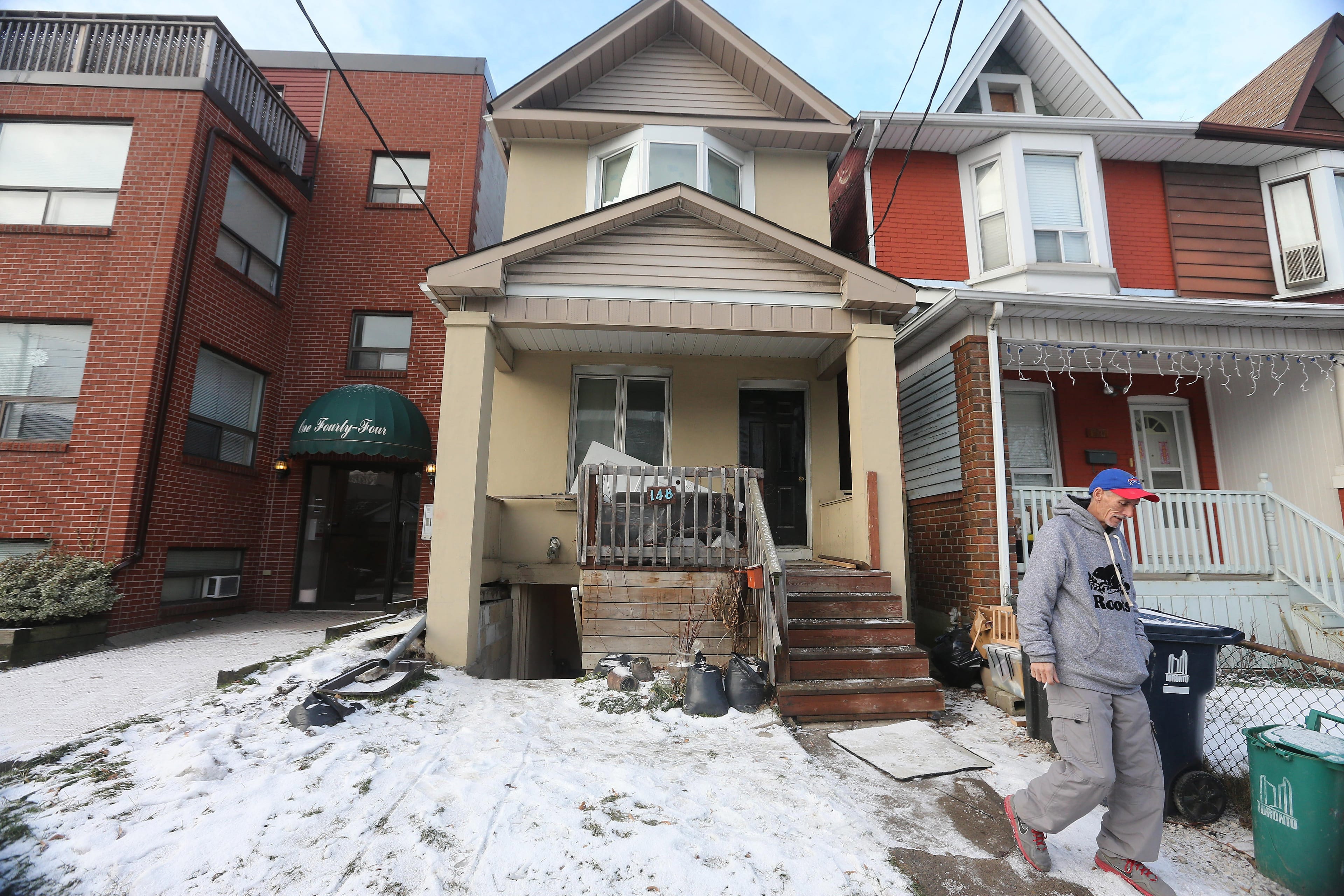 James Ribble, a formerly homeless man who has been living in a basement apartment with a busted foundation and leaking sewer gas for three months, waits for his landlord to pay part of his January rent in December 2017 in Toronto. (Steve Russell/Toronto Star via Getty Images)