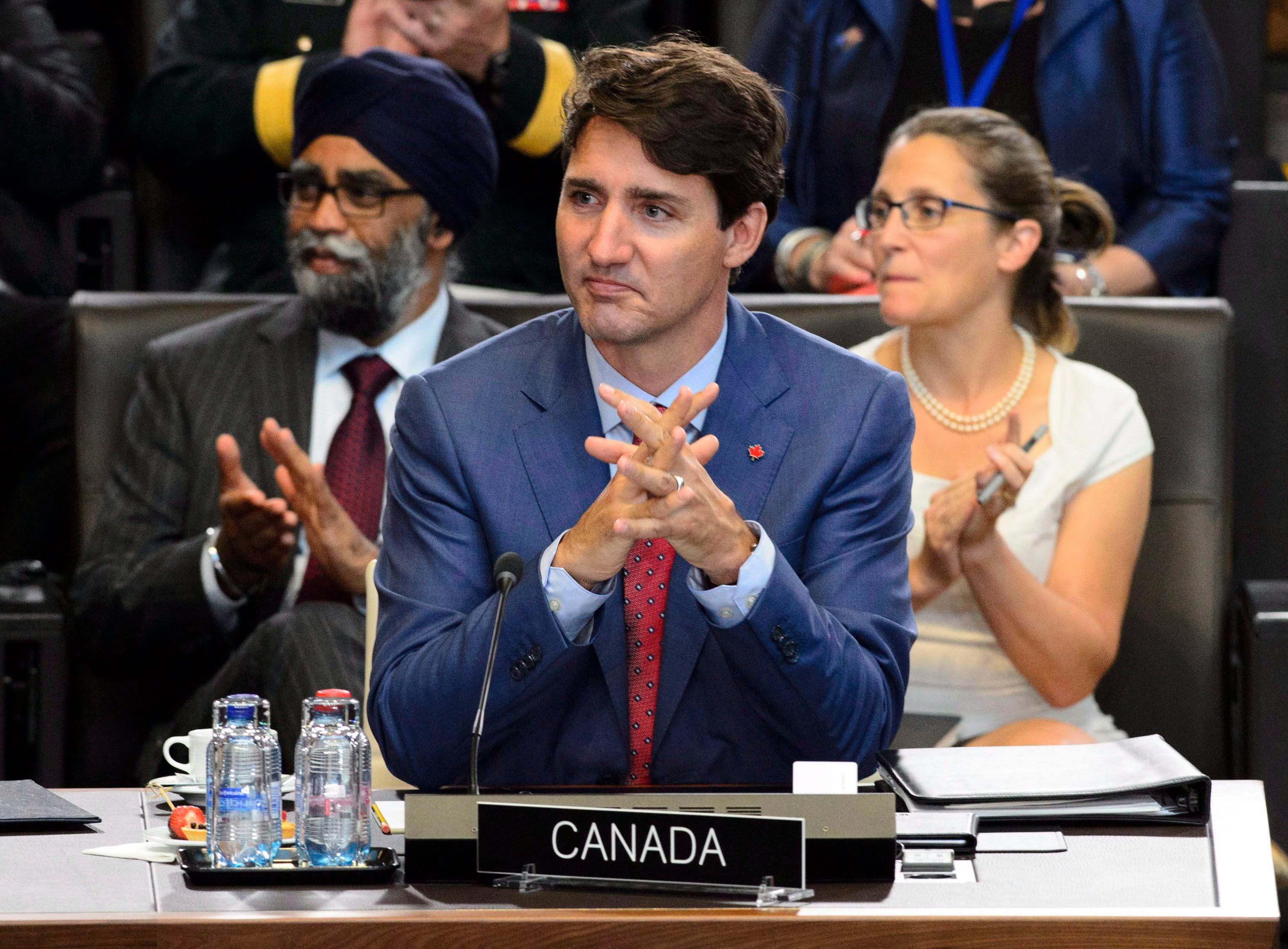 Prime Minister Justin Trudeau, middle, Defence Minister Harjit Sajjan, left, and Minister of Foreign Affairs Chrystia Freeland take part in North Atlantic Council Working Session at the NATO Summit in Brussels, Belgium on July 11, 2018. (Sean Kilpatrick/CP)