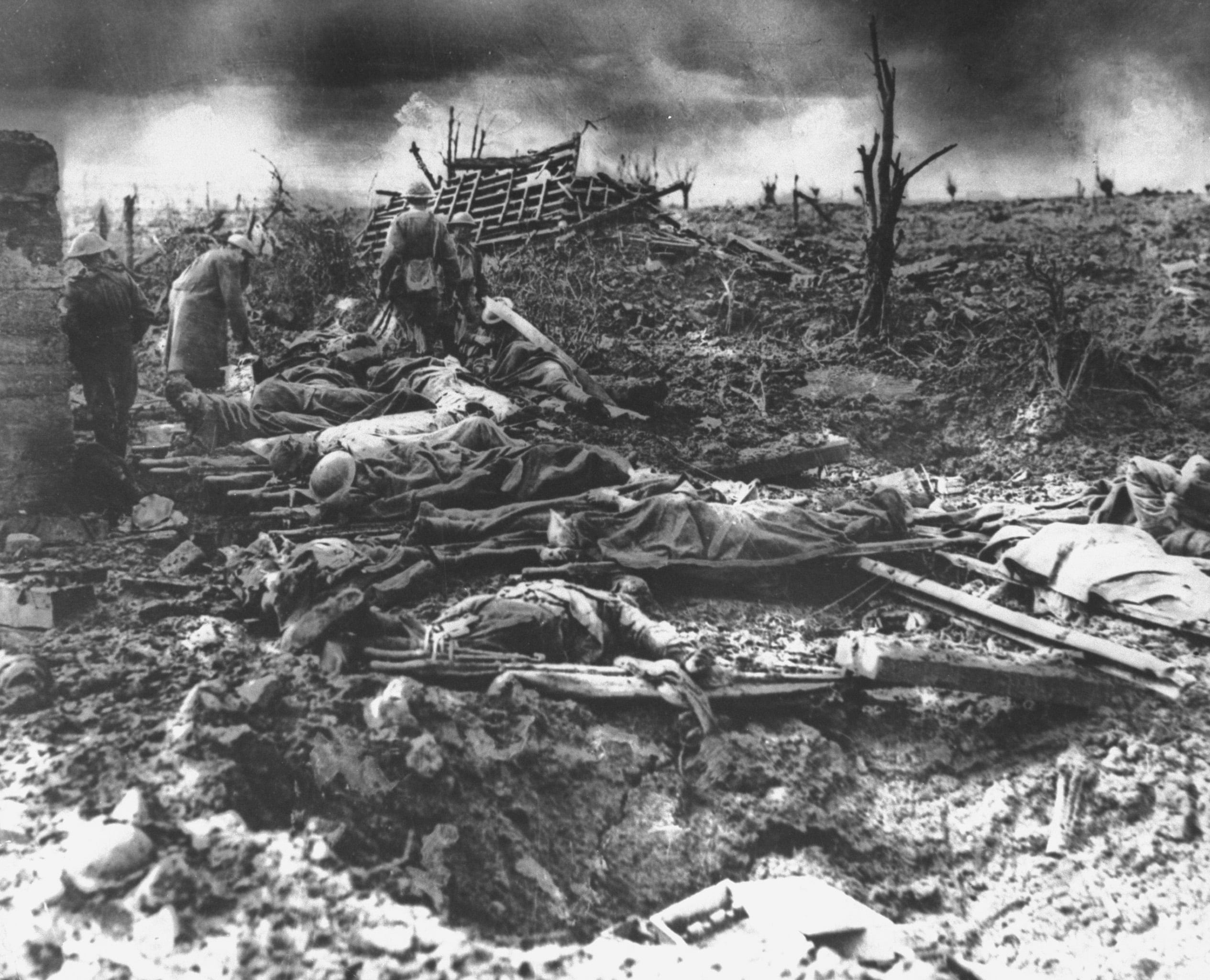 Dawn rising on muddy, horrific battlefield of Passchendaele as soldiers tend to the dead during WWI.  (Mansell/The LIFE Picture Collection/Getty Images)