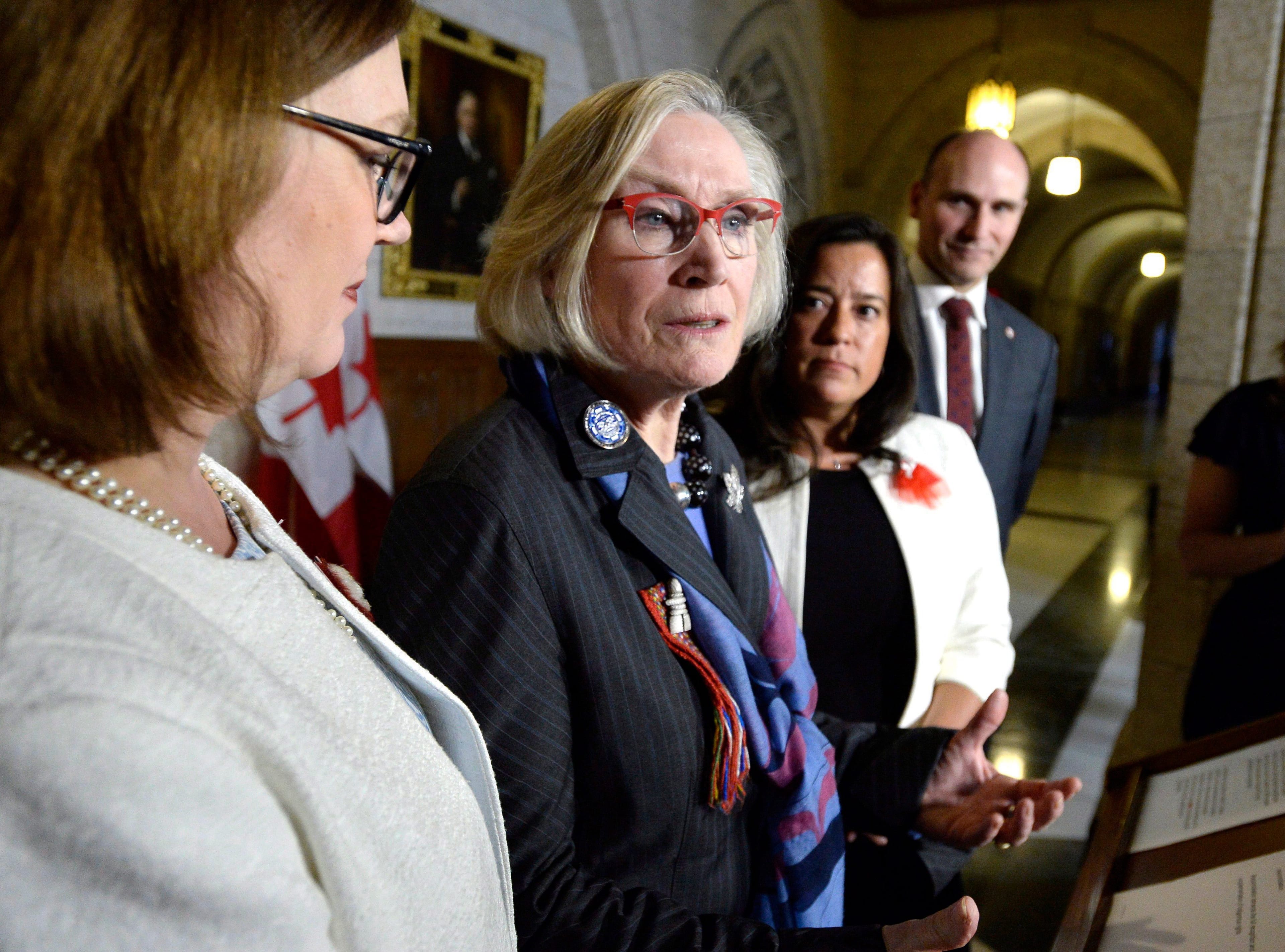 Minister of Crown-Indigenous Relations Carolyn Bennett, speaks about the framework for the recognition and implementation of Indigenous rights, as Minister of Indigenous Services Jane Philpott (left), Minister of Justice Jody Wilson-Raybould, and Minister of Families, Children and Social Development Jean-Yves Duclos look on, in  the House of Commons on Feb. 14, 2018. (THE CANADIAN PRESS/Justin Tang)