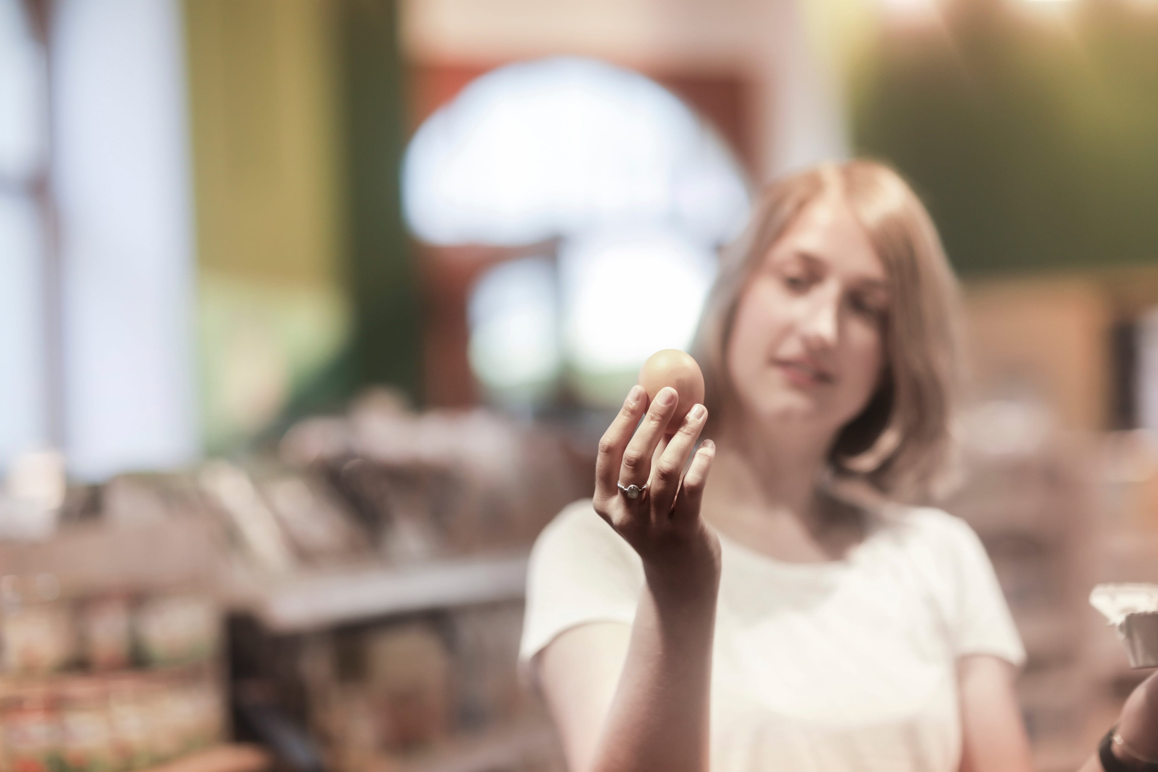 Woman standing in a supermarket checking eggs