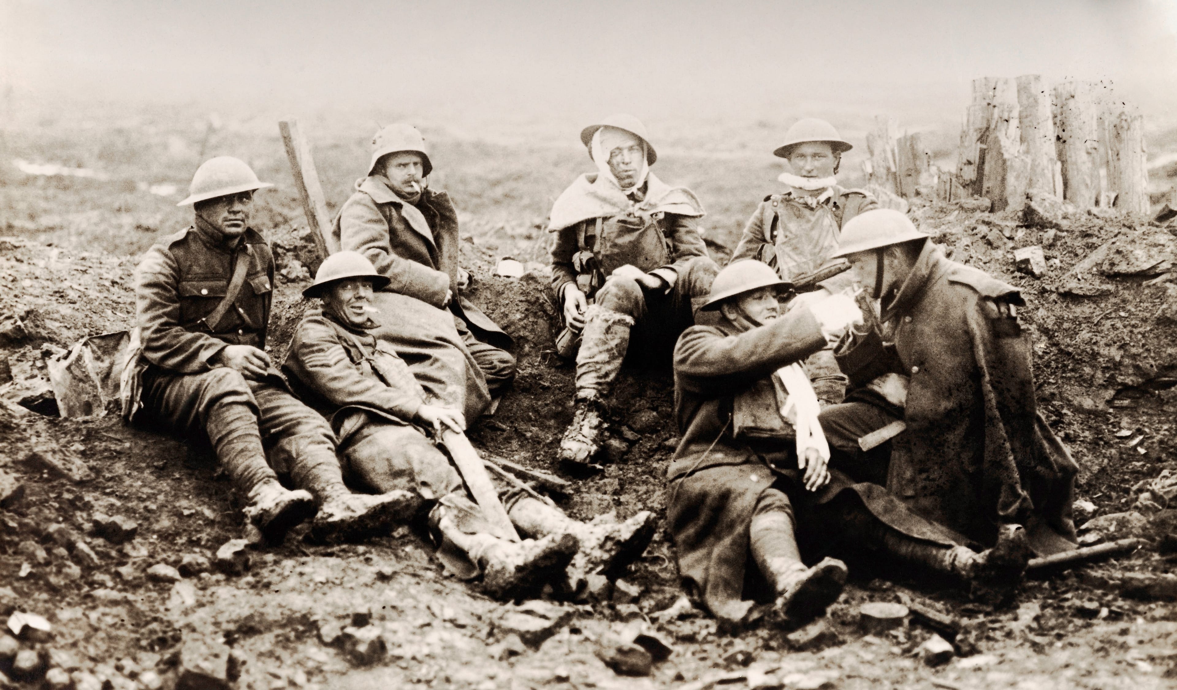 Wounded Canadian soldiers rest near a smashed German pill-box on the Western Front before moving on to a dressing station during World War One, circa 1916.   (Popperfoto/Getty Images)