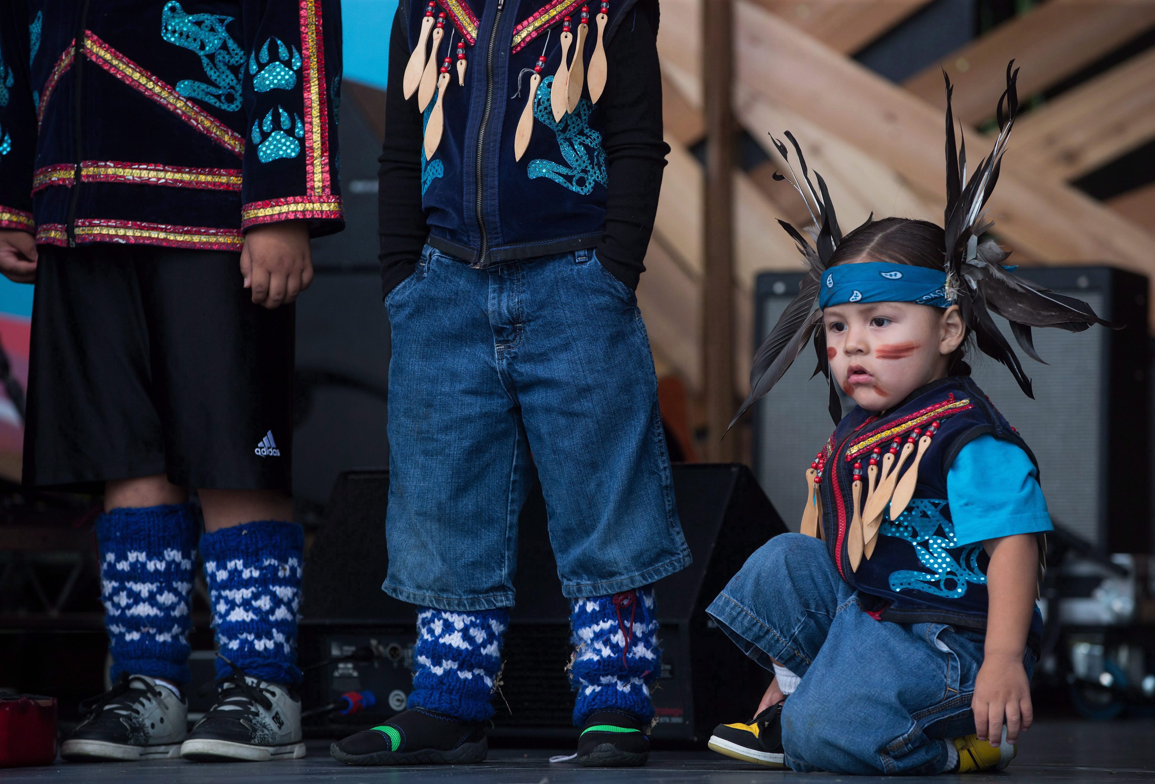 A young First Nations boy waits to dance after the Walk for Reconciliation in Vancouver, B.C., on Sunday September 24, 2017. The two kilometre walk was held to promote positive relations between Indigenous and non-Indigenous people in Canada. THE CANADIAN PRESS/Darryl Dyck