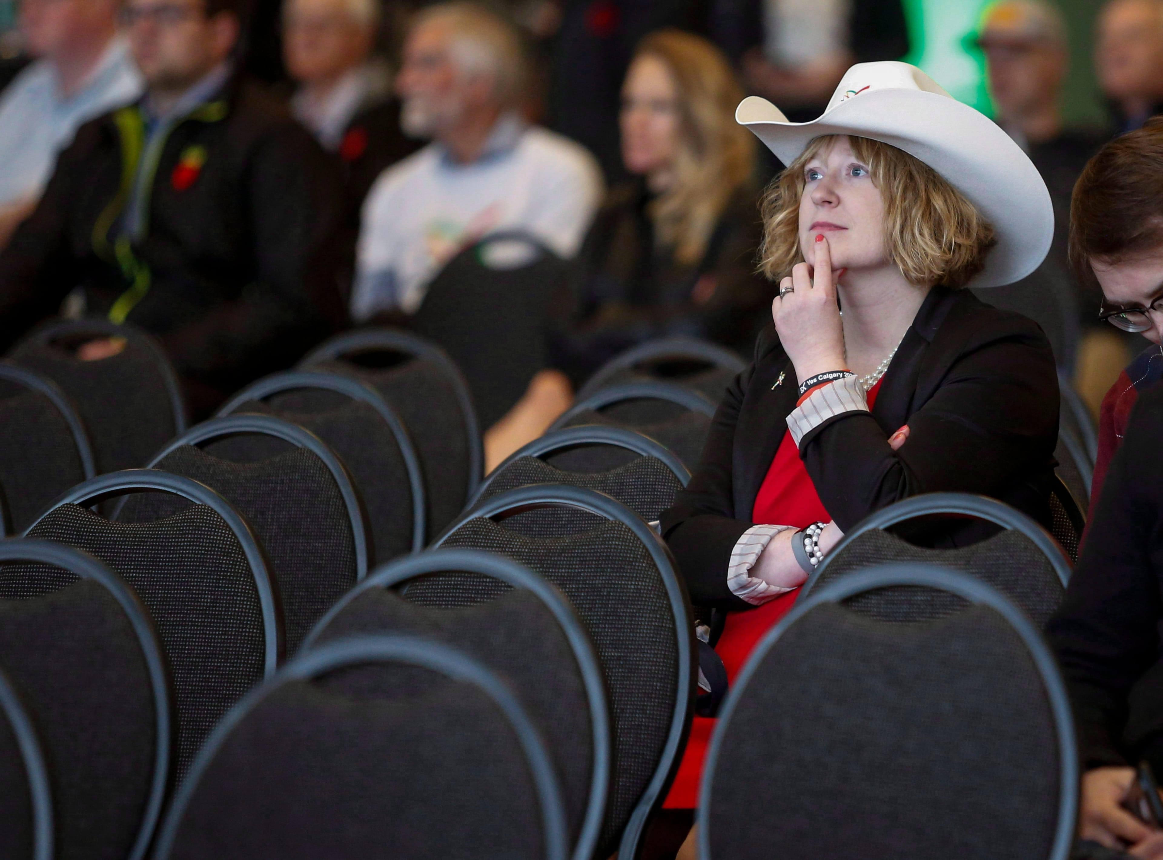 An Olympic bid supporter listens to speeches during a rally in Calgary on Nov. 5 (THE CANADIAN PRESS/Jeff McIntosh)