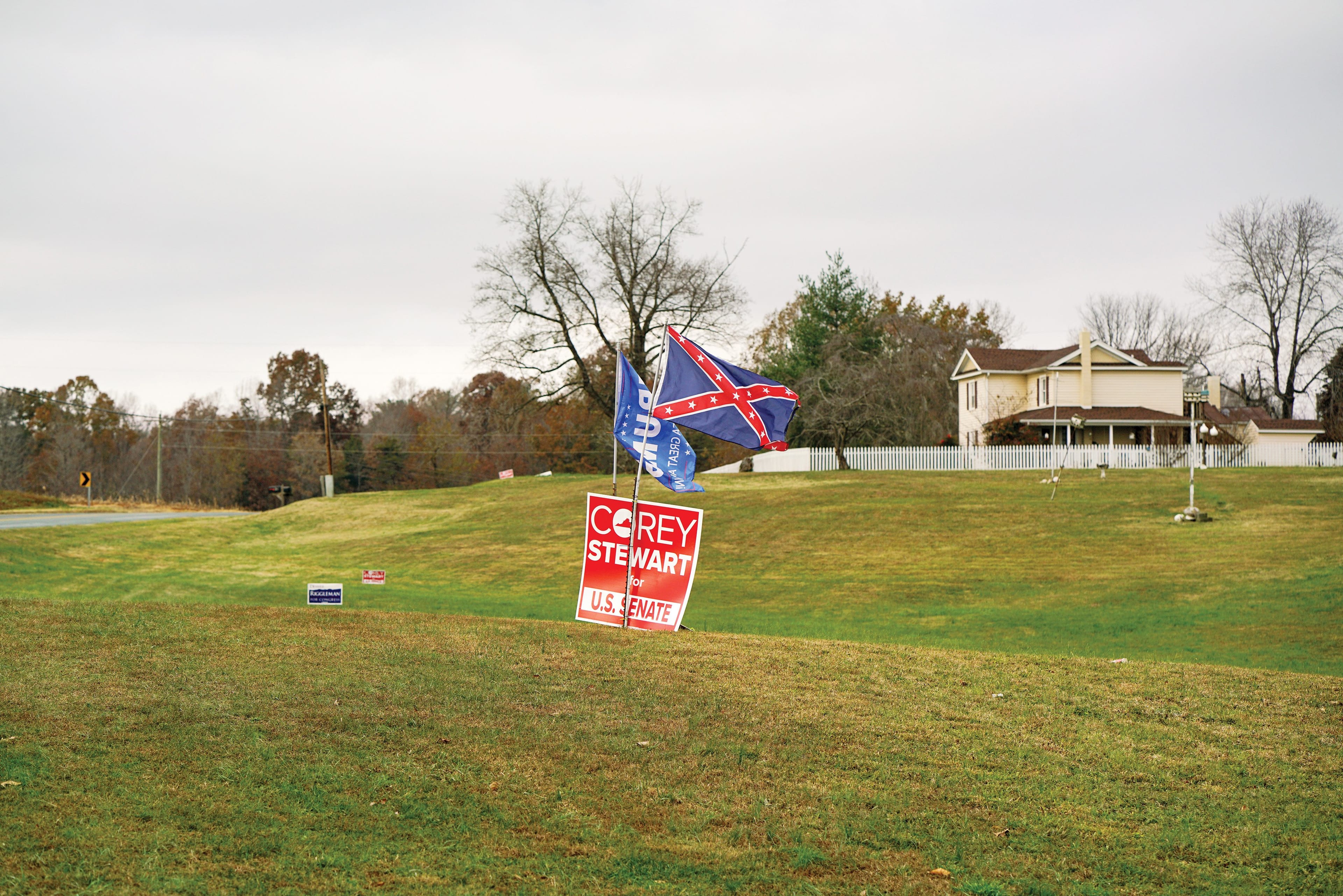 Jay Miller pairs a confederate flag with a Trump flag in his front lawn between Somerset and Madison, Va. on Sunday, Nov. 19, 2018. (Photograph by Maura Friedman)