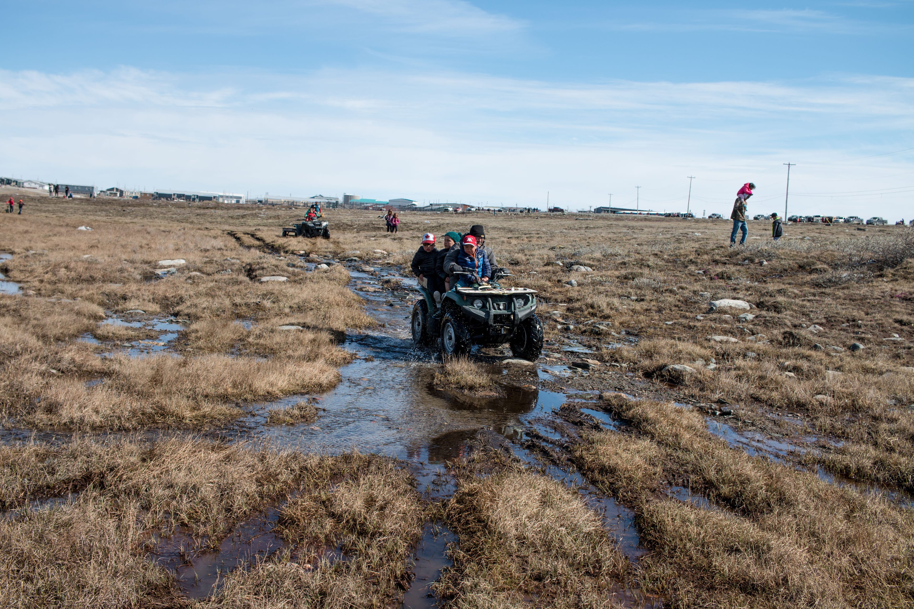 Children ride on an ATV with an elder just outside of Rankin Inlet on Canada Day 2018. (Cody Punter)