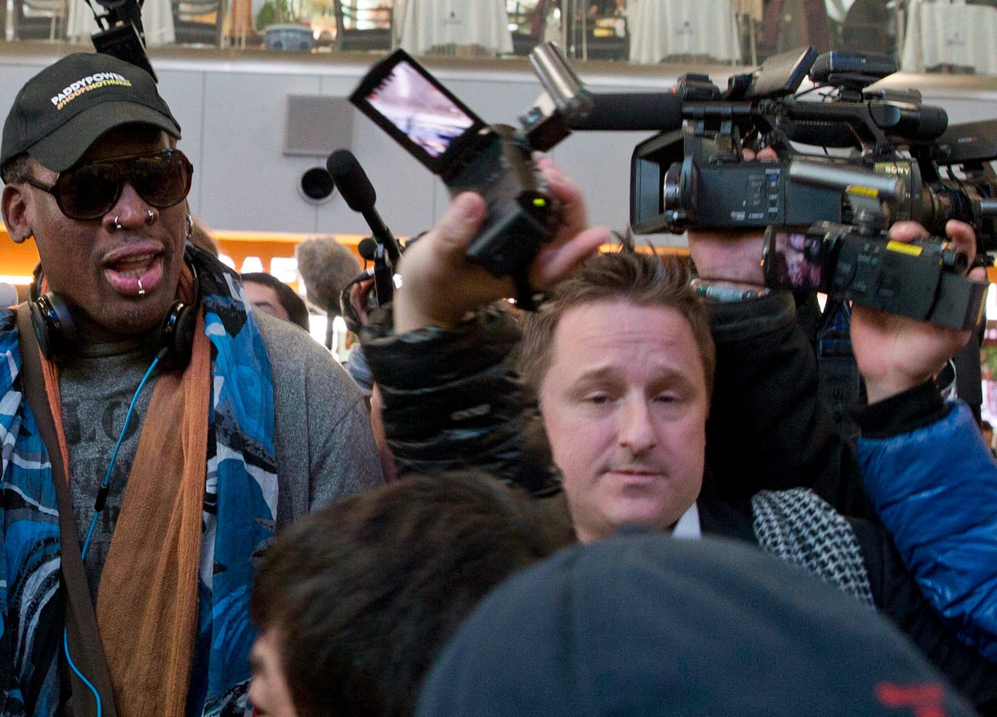 Canadian Michael Spavor is seen with former NBA star Dennis Rodman on arrival at the capital airport in Beijing, China, for a flight to North Korea on Dec. 19, 2013 (AP Photo/Ng Han Guan, File)