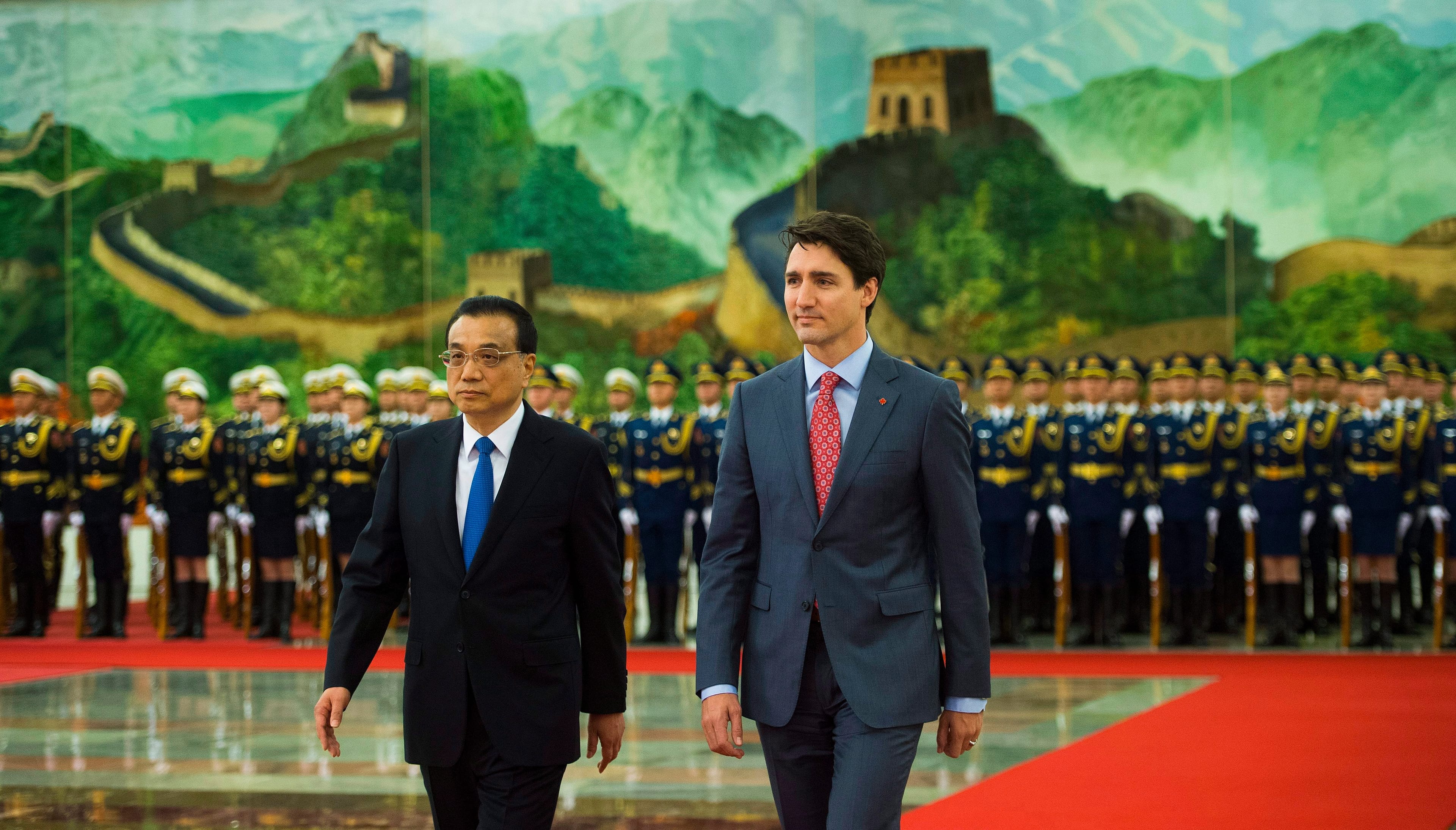 Prime Minister Justin Trudeau walks with Chinese Premier Li Keqiang during a welcoming ceremony at the Great Hall of the People in Beijing on Dec. 4, 2017. (Sean Kilpatrick/CP)