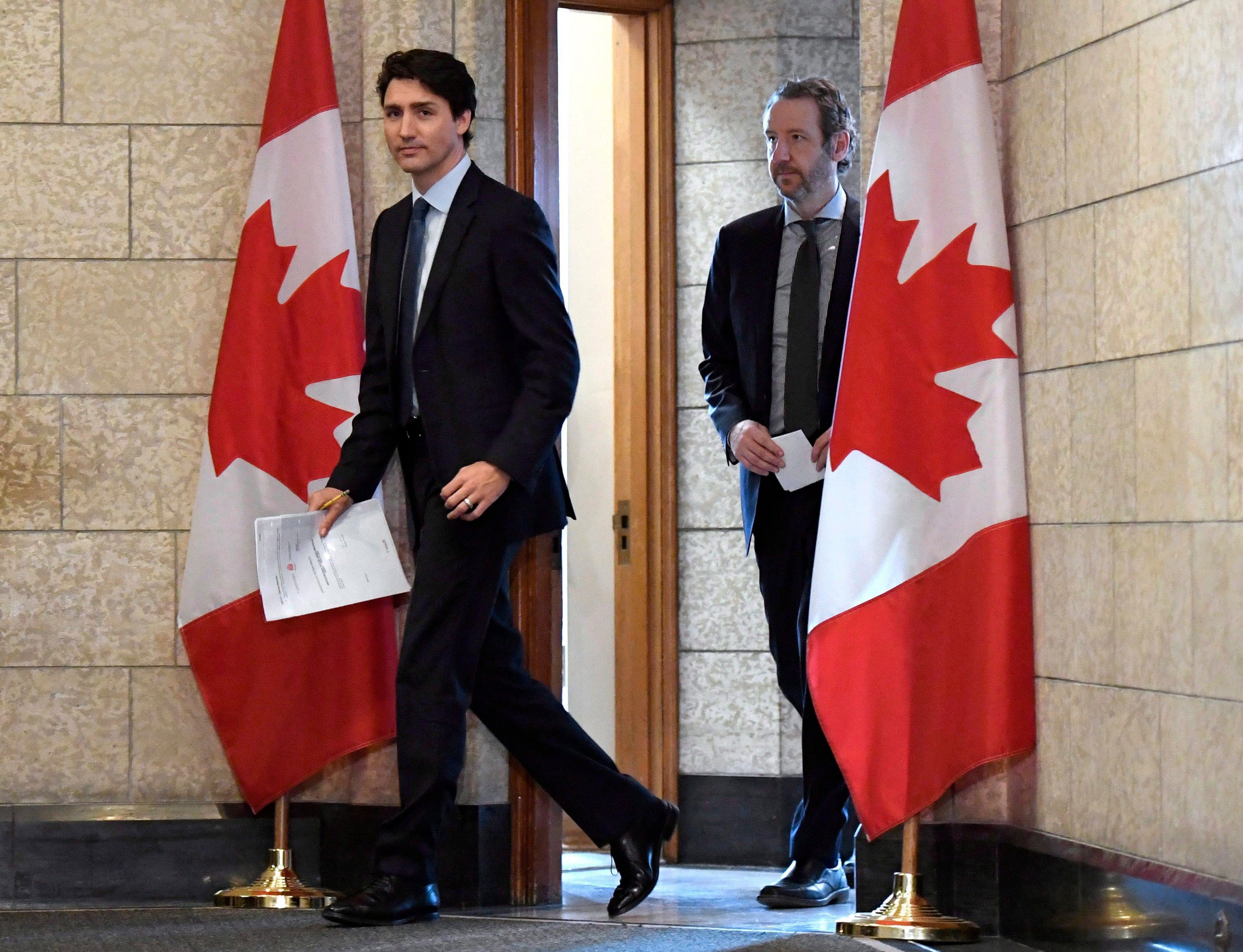 Trudeau leaves his office with his principal secretary Gerald Butts to attend an emergency cabinet meeting on Parliament Hill on Tuesday, April 10, 2018. (THE CANADIAN PRESS/Justin Tang)
