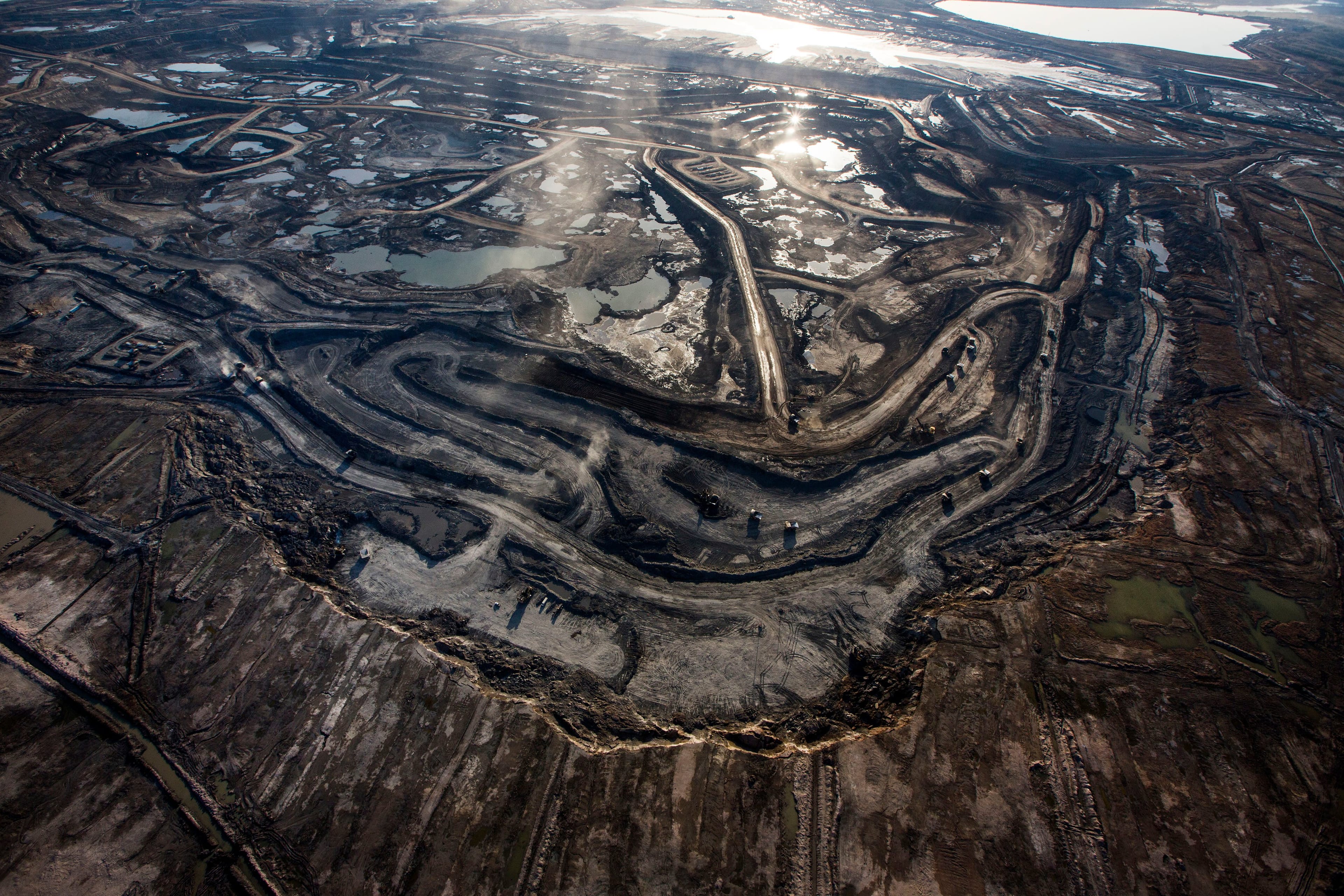 Trucks and machinery along routes within the Suncore Oil Sands site near to Fort McMurray in Northern Alberta. (David Levene/The Guardian/eyevine/Redux)