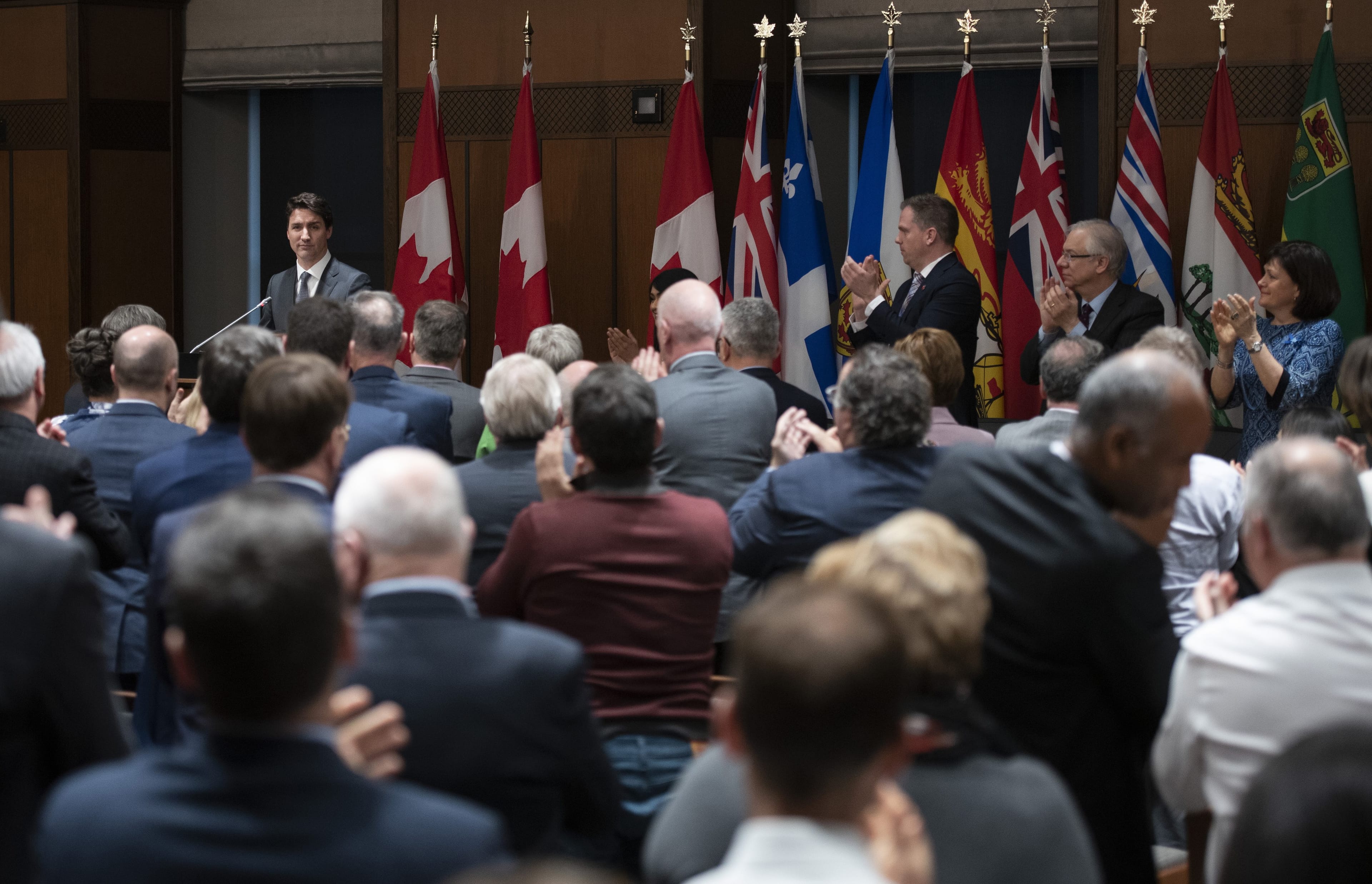 Members of the Liberal Caucus give a standing ovation to Prime Minister Justin Trudeau after his speech at an evening caucus meeting on Parliament Hill in Ottawa on Tuesday, April 2, 2019. Trudeau has kicked both former attorney general Jody Wilson-Raybould and fellow ex-cabinet minister Jane Philpott out of the Liberal caucus. (Justin Tang/CP)