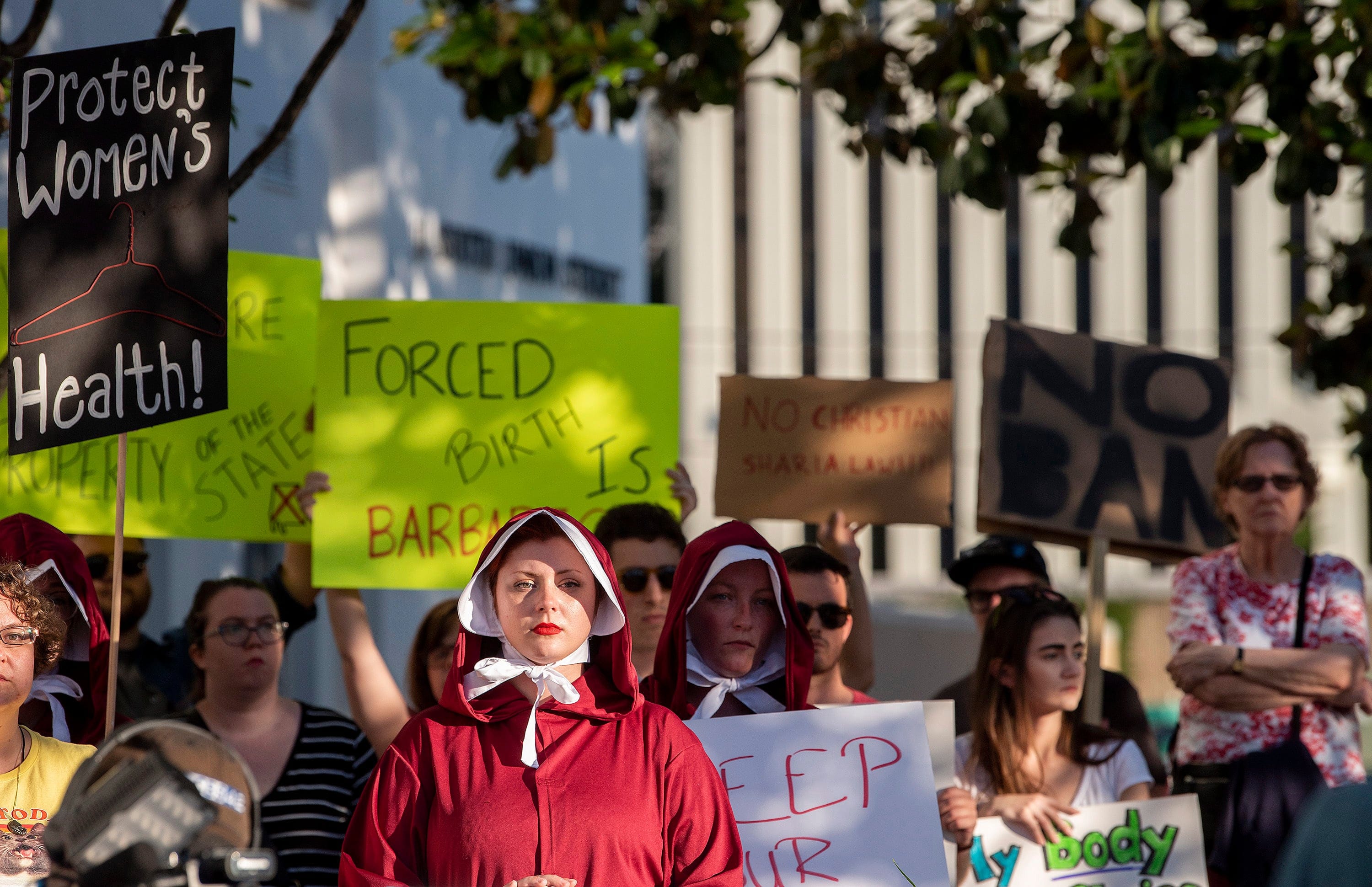 May 14 photo, Margeaux Hartline, dressed as a handmaid, joins a rally against HB314, the near-total ban on abortion bill, outside of the Alabama Statehouse in Montgomery, Ala. (Mickey Welsh/The Montgomery Advertiser/AP)