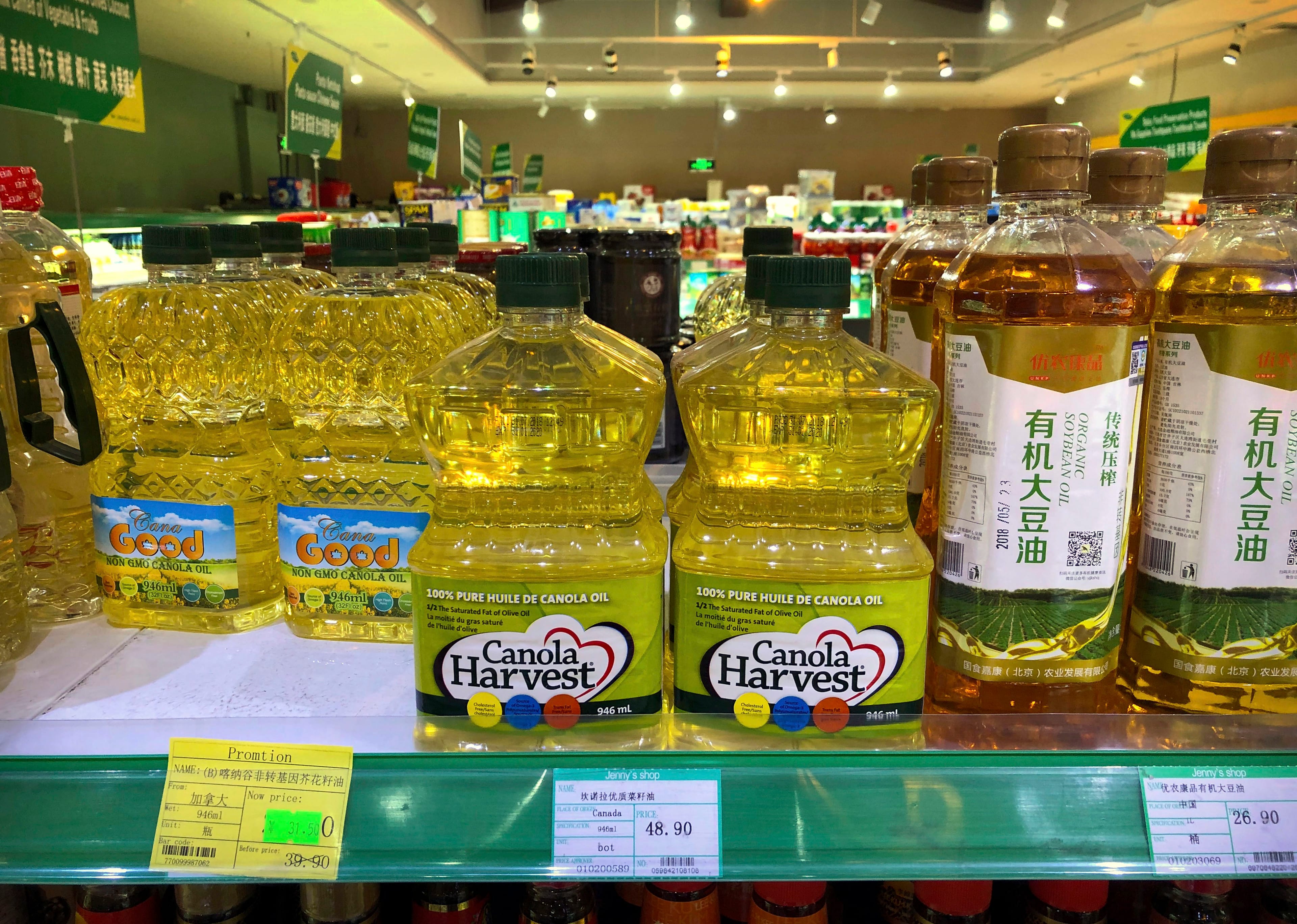 Bottles of Canadian-made canola oil on a store shelf in Beijing (Mark Schiefelbein/AP)