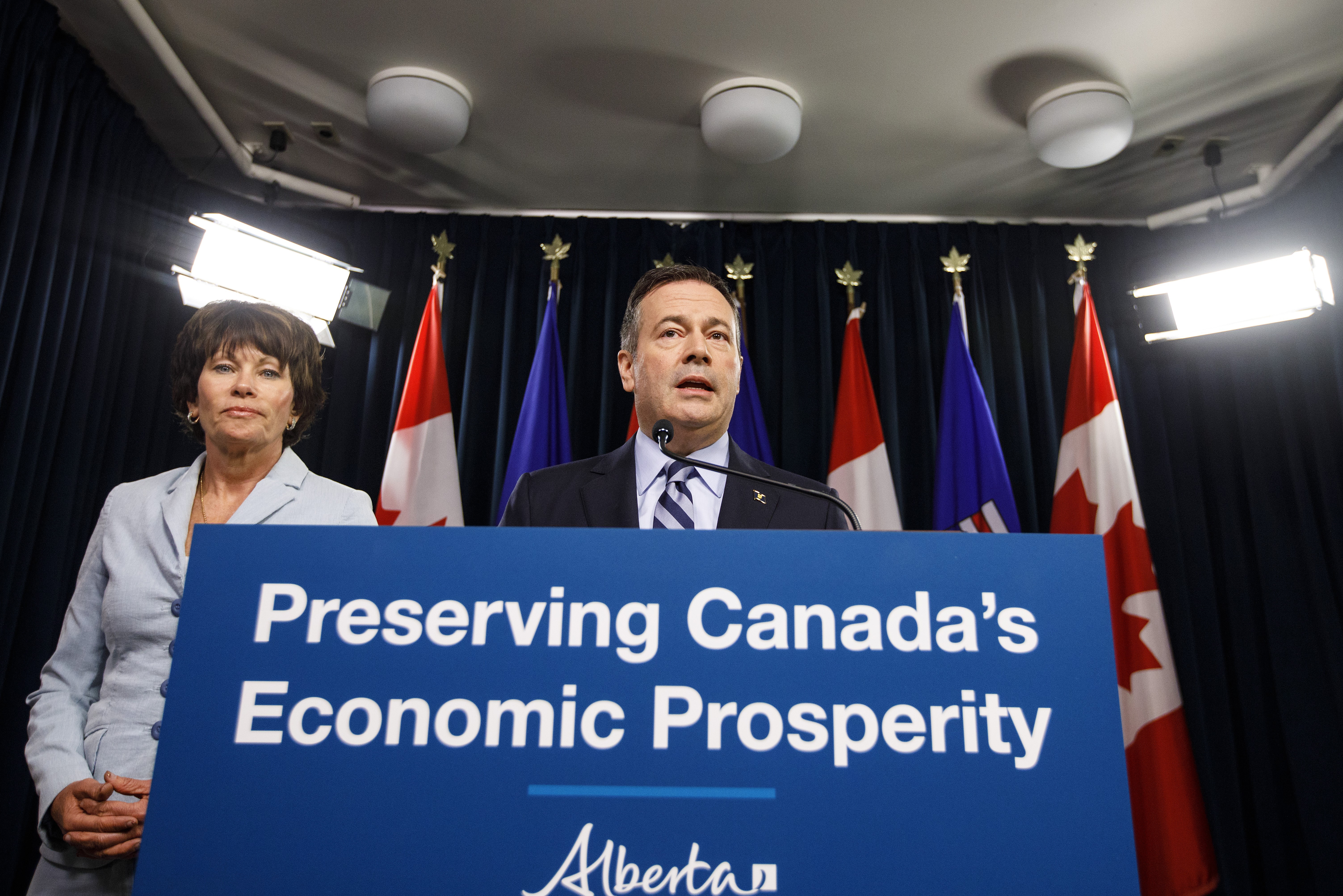 Kenney speaks on Wednesday with Alberta's newly appointed minister of energy, Sonya Savage (Jason Franson/CP)