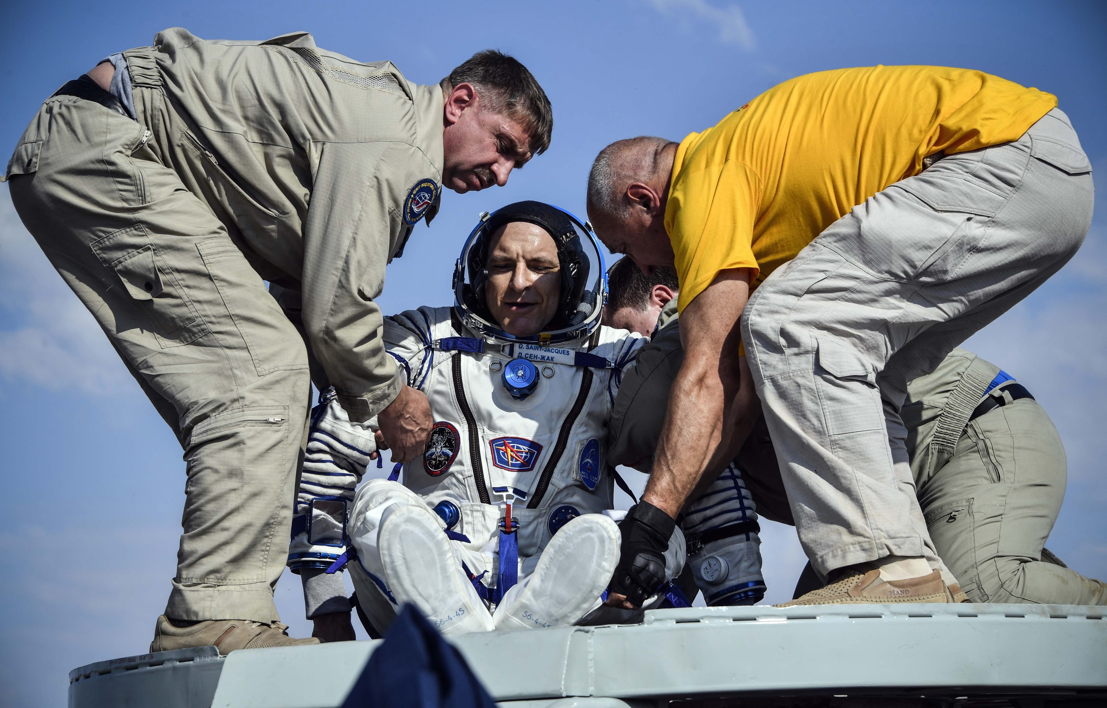 Ground personnel help David Saint-Jacques of the Canadian Space Agency to get out of the Soyuz MS-11 capsule shortly after landing in a remote area outside the town of Dzhezkazgan, Kazakhstan, on June 25, 2019. (Alexander Nemenov/AFP/Getty Images)