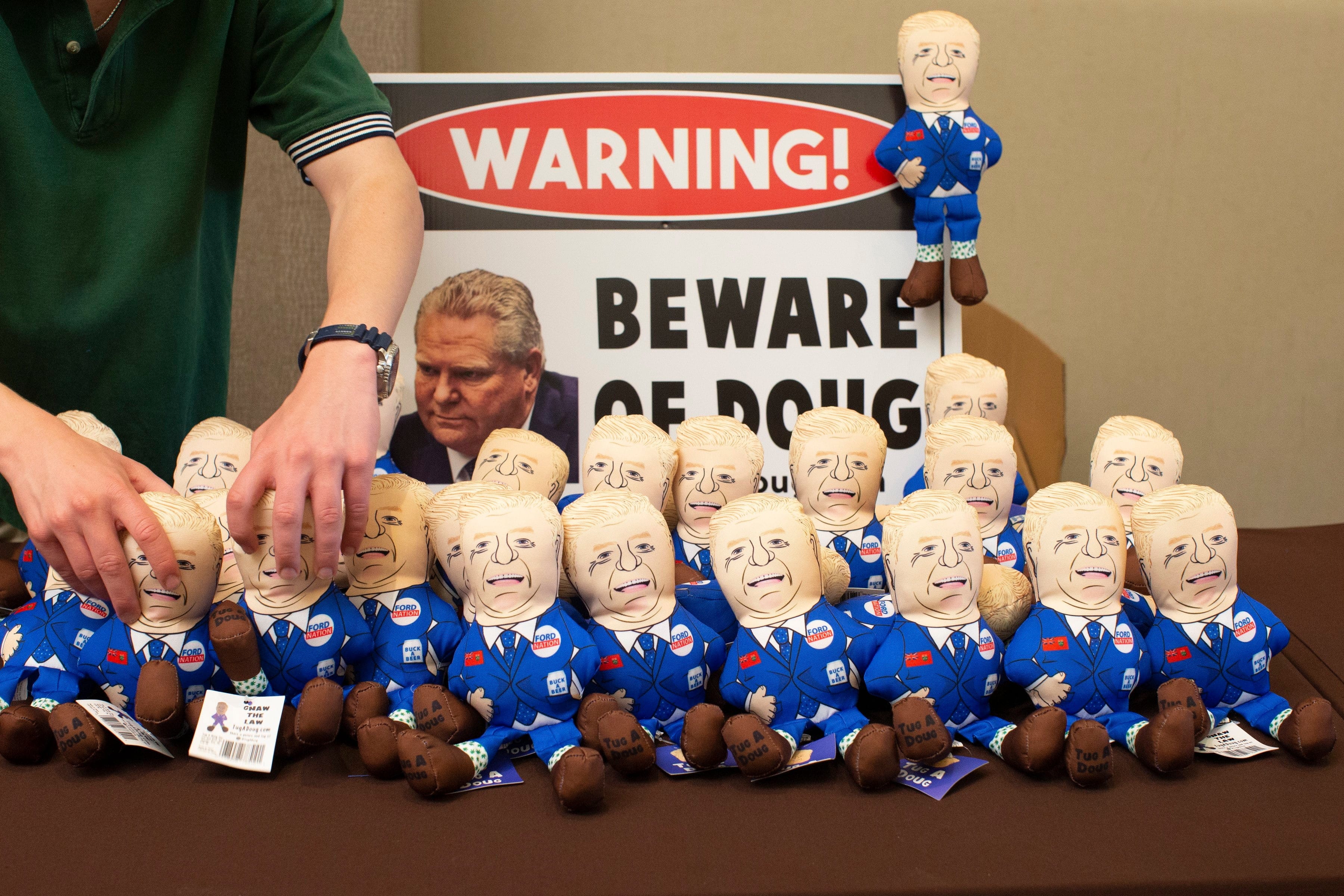 A volunteer arranges a stall selling dog chew toys depicting Ontario Premier Doug Ford at the Ontario Liberal Party's 2019 annual general meeting in Toronto, on June 7. (Chris Young/CP)