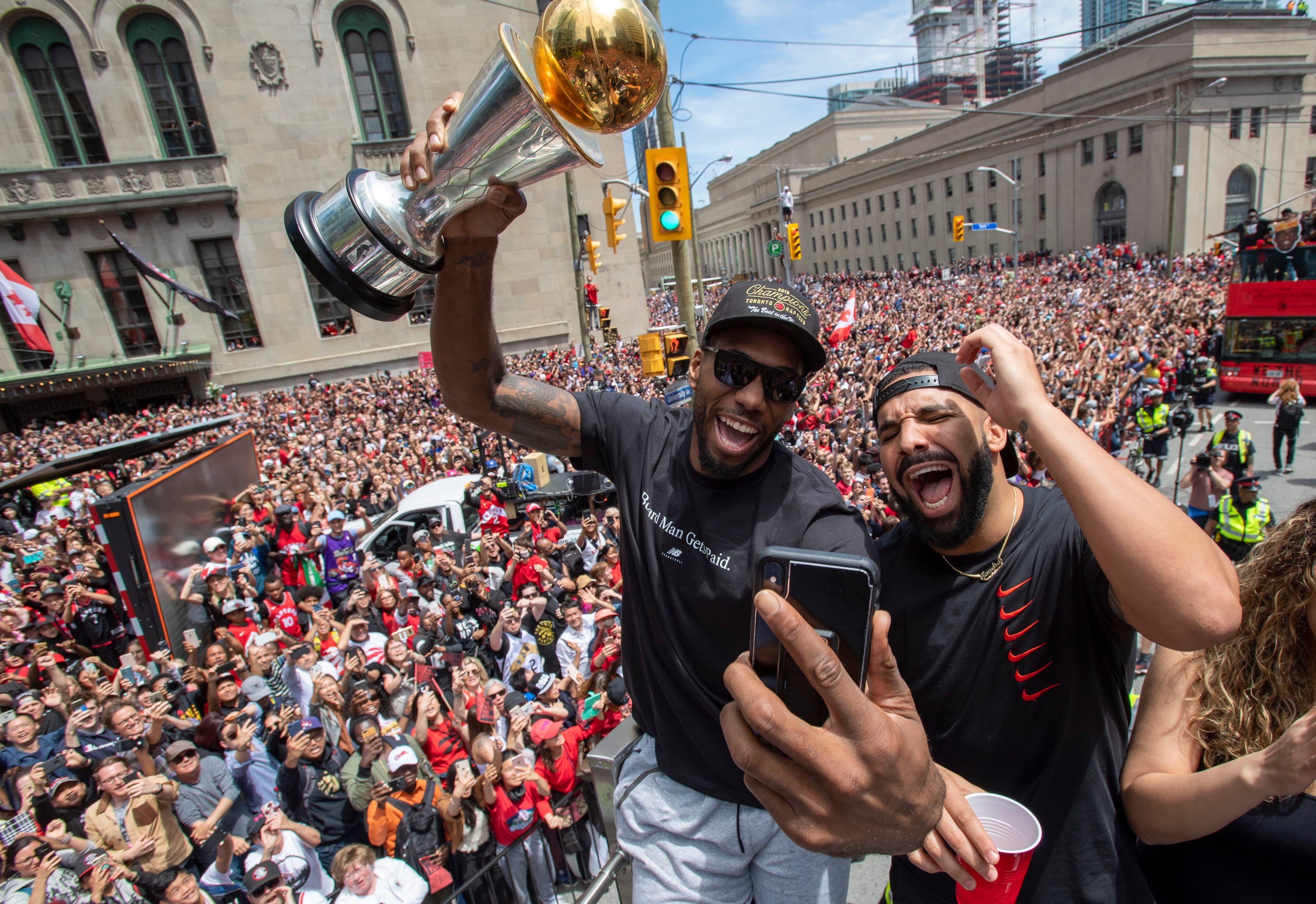 Leonard holds his MVP trophy with Drake during the parade in Toronto on Monday. (Frank Gunn/CP)