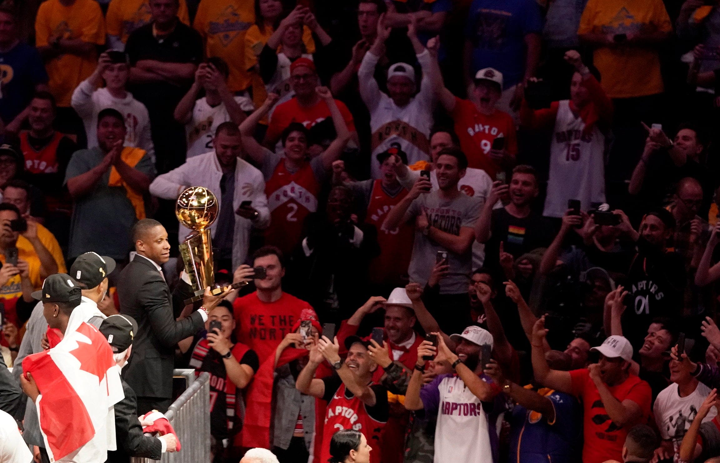 Ujiri holding the championship trophy after the Raptors defeated the Golden State Warriors on June 13. (Tony Avelar/AP)