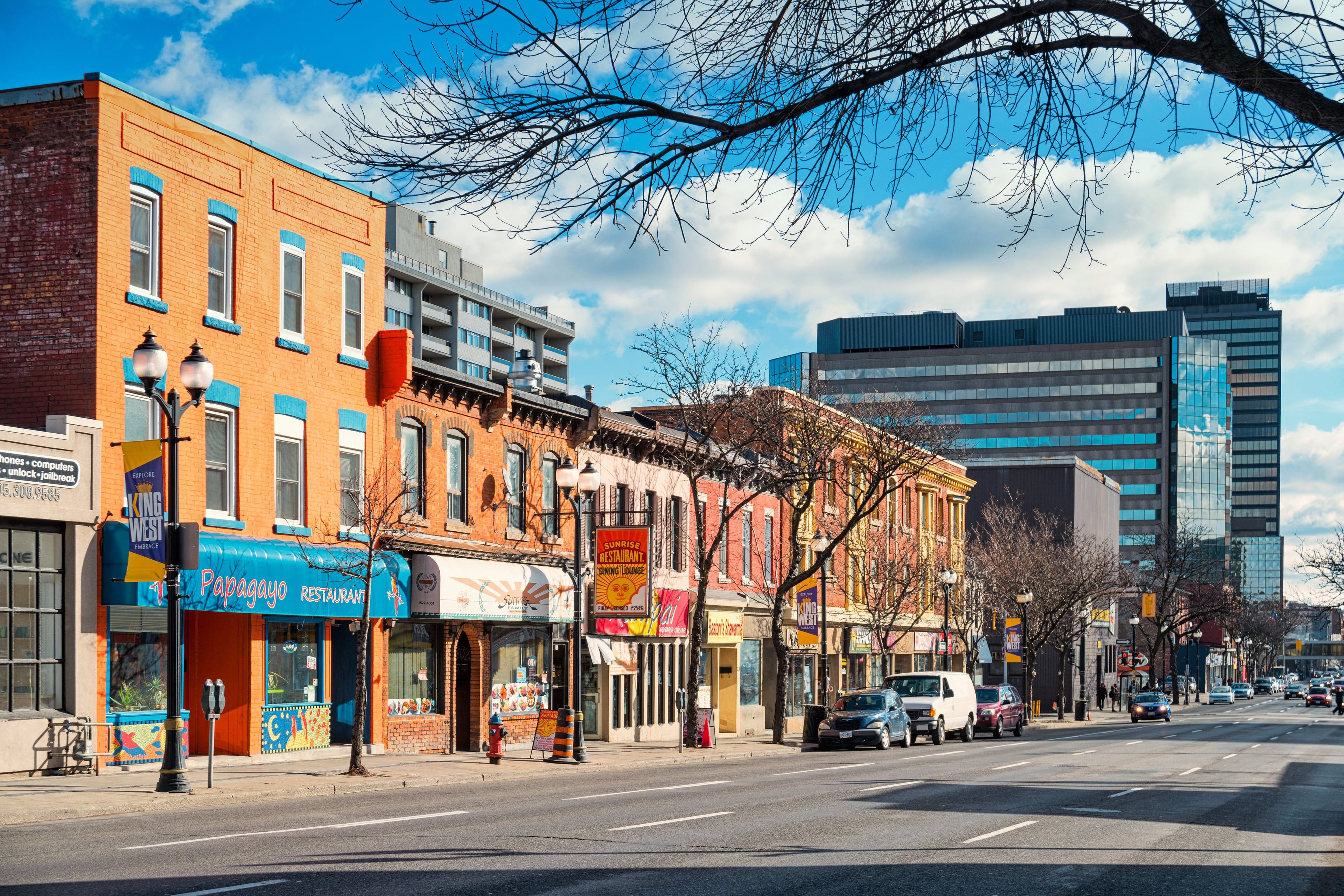 Photo of colorful restaurants and businesses on King Street West in downtown Hamilton, Ontario, Canada.