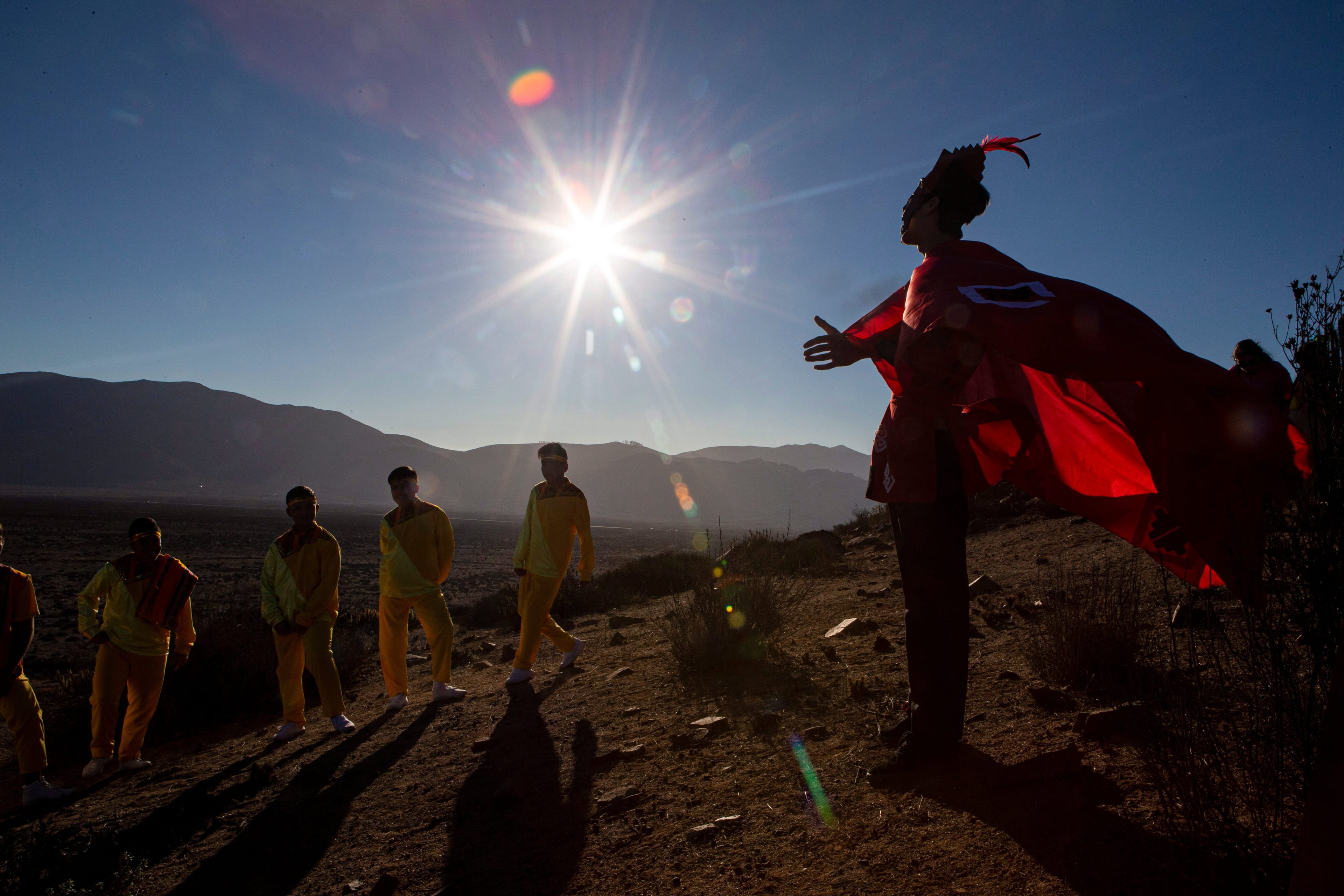 A youth dressed as a shaman arrives to take part in a photo session before Tuesday's total solar eclipse, in La Higuera, Chile, Monday, July 1, 2019. (AP Photo/Esteban Felix)
