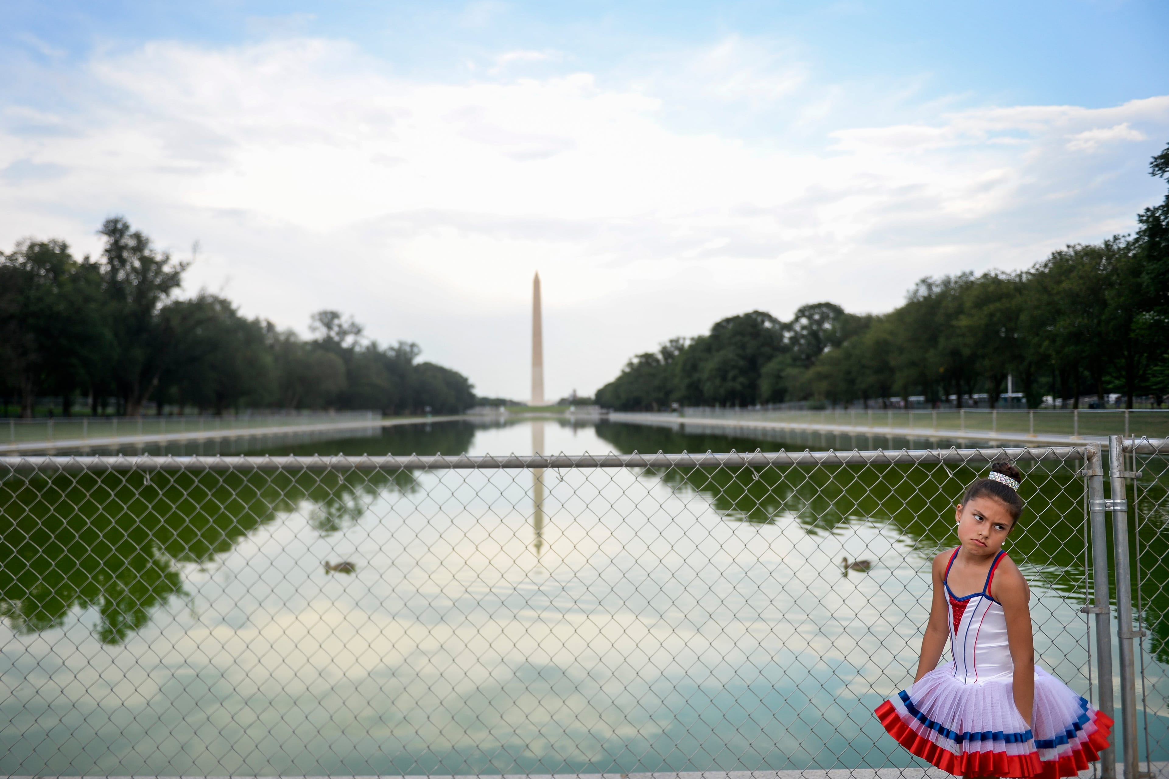 A visitor stands in front of temporary fencing installed along the National Mall on July 2, 2019, for President Donald Trump's 'Salute to America' event at the Lincoln Memorial (Caroline Brehman/CQ Roll Call)