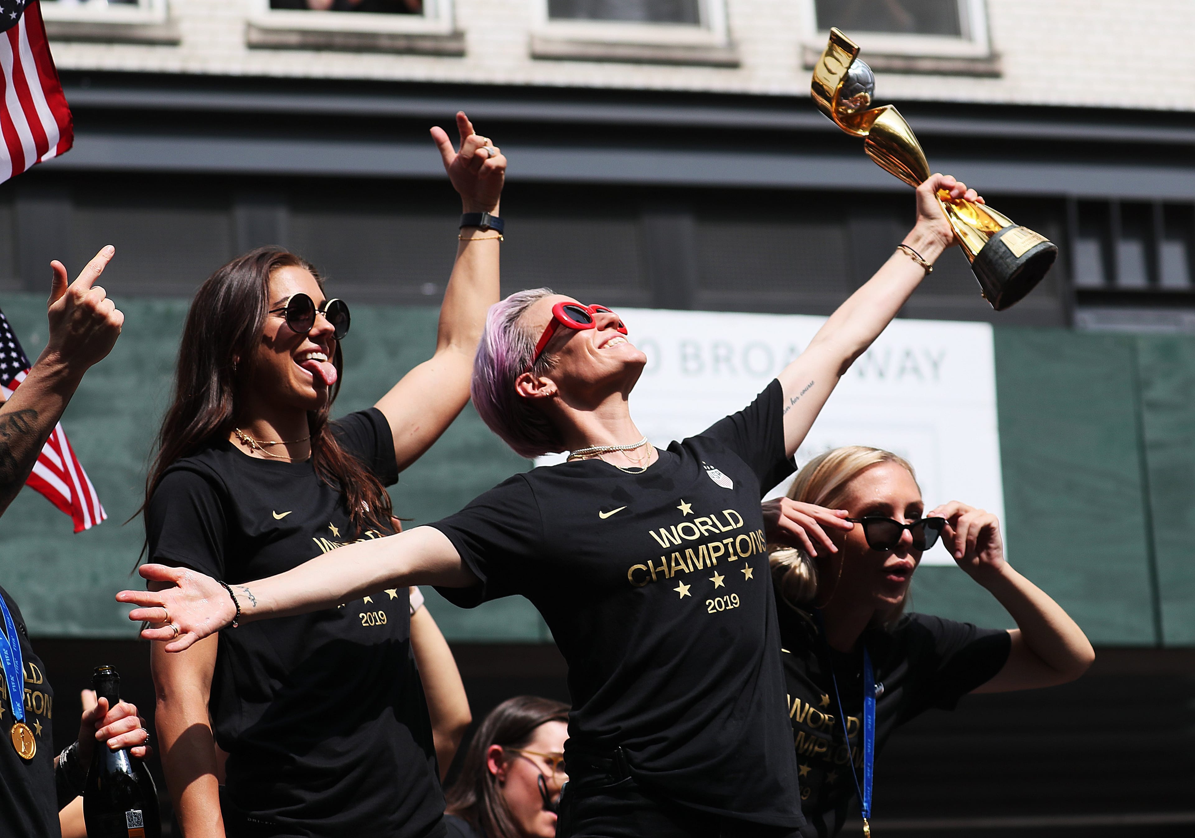 Rapinoe, centre, celebrating with teammates Alex Morgan and Allie Long during the victory parade in New York (Al Bello/Getty Images)