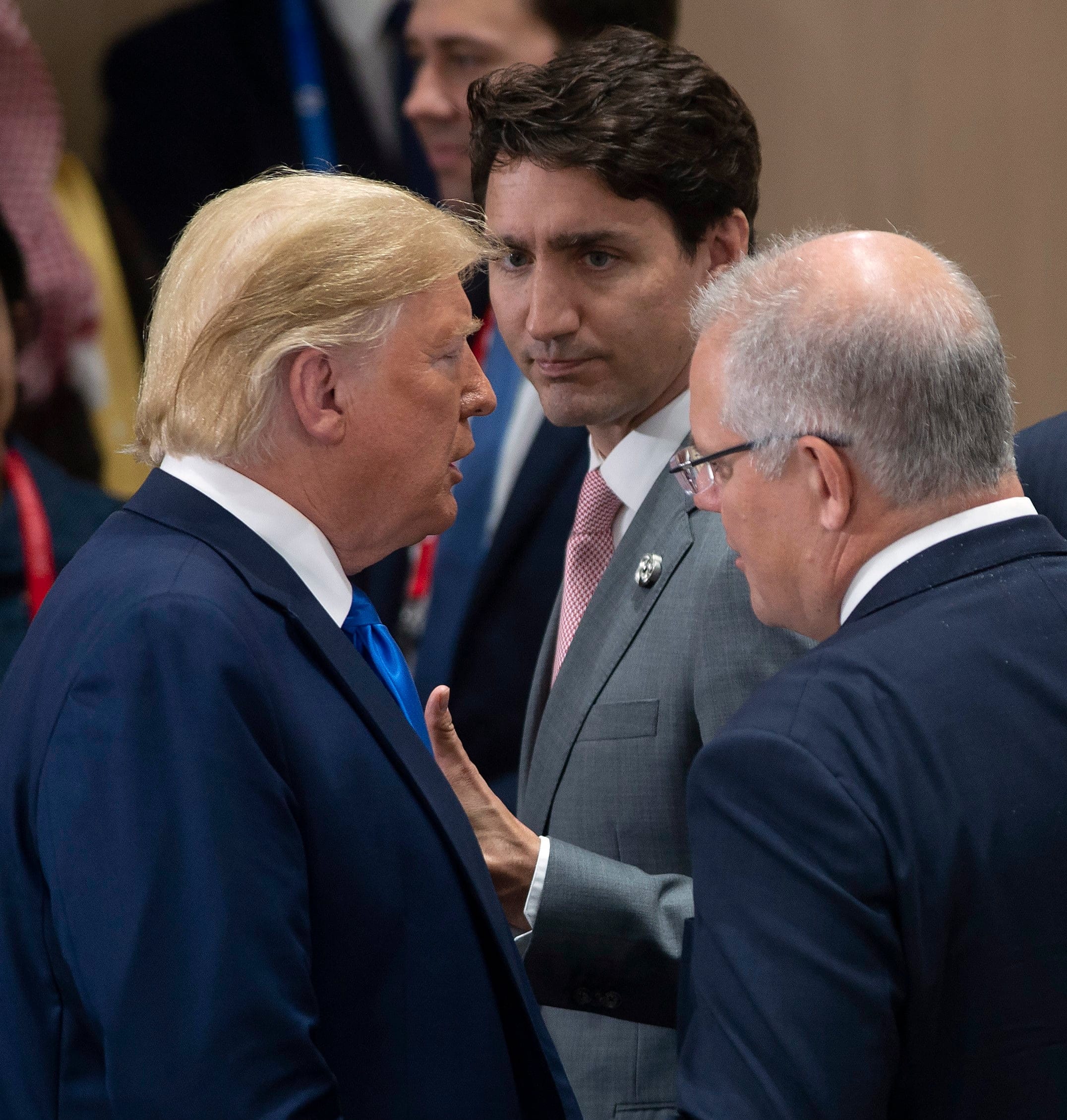 Canadian Prime Minister Justin Trudeau, centre,  gives a thumbs up as he talks with United States President Donald Trump before a plenary session at the G20 Summit in Osaka, Japan, Saturday June 29, 2019. (Adrian Wyld/CP)