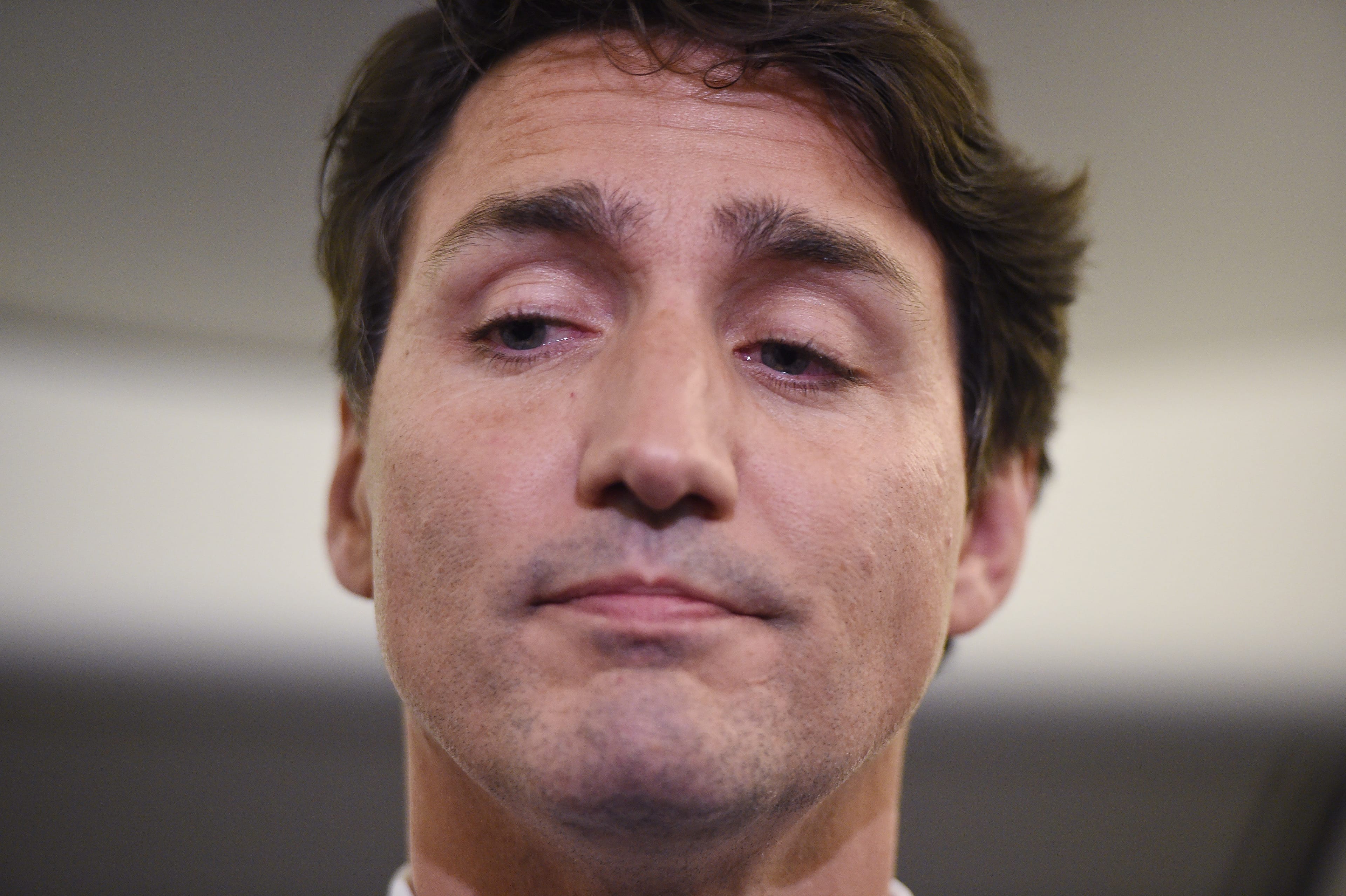 Liberal Leader Justin Trudeau reacts as he makes a statement in regards to photo coming to light of himself from 2001 wearing "brownface" during a scrum on his campaign plane in Halifax, N.S., on Wednesday, September 18, 2019. (Sean Kilpatrick/CP)