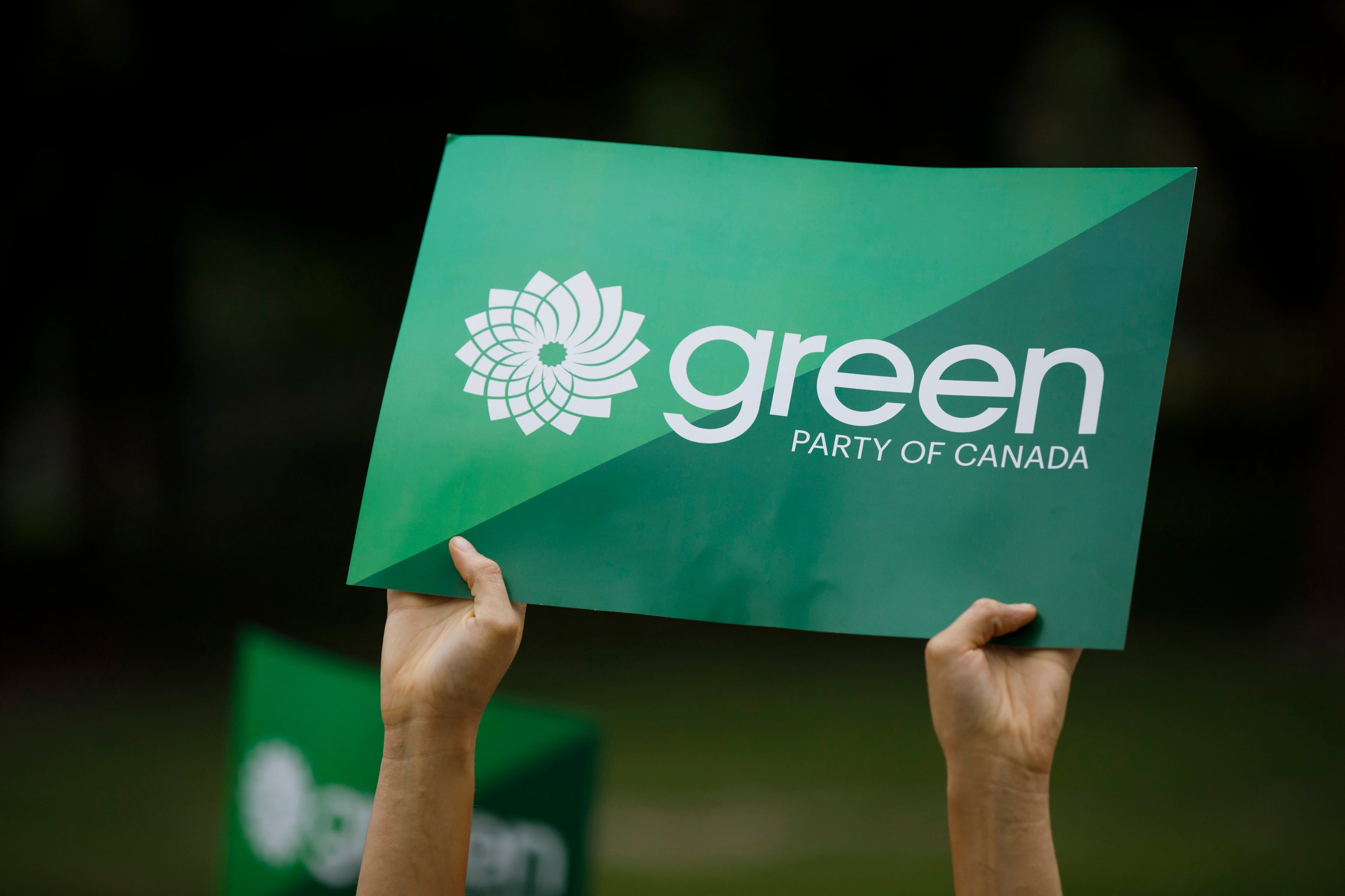 A supporter holds a sign for the Green Party of Canada as a group of candidates and supporters marched towards a discussion on climate with Green Party leader Elizabeth May in Toronto, Tuesday, Sept. 3, 2019. THE CANADIAN PRESS/Cole Burston