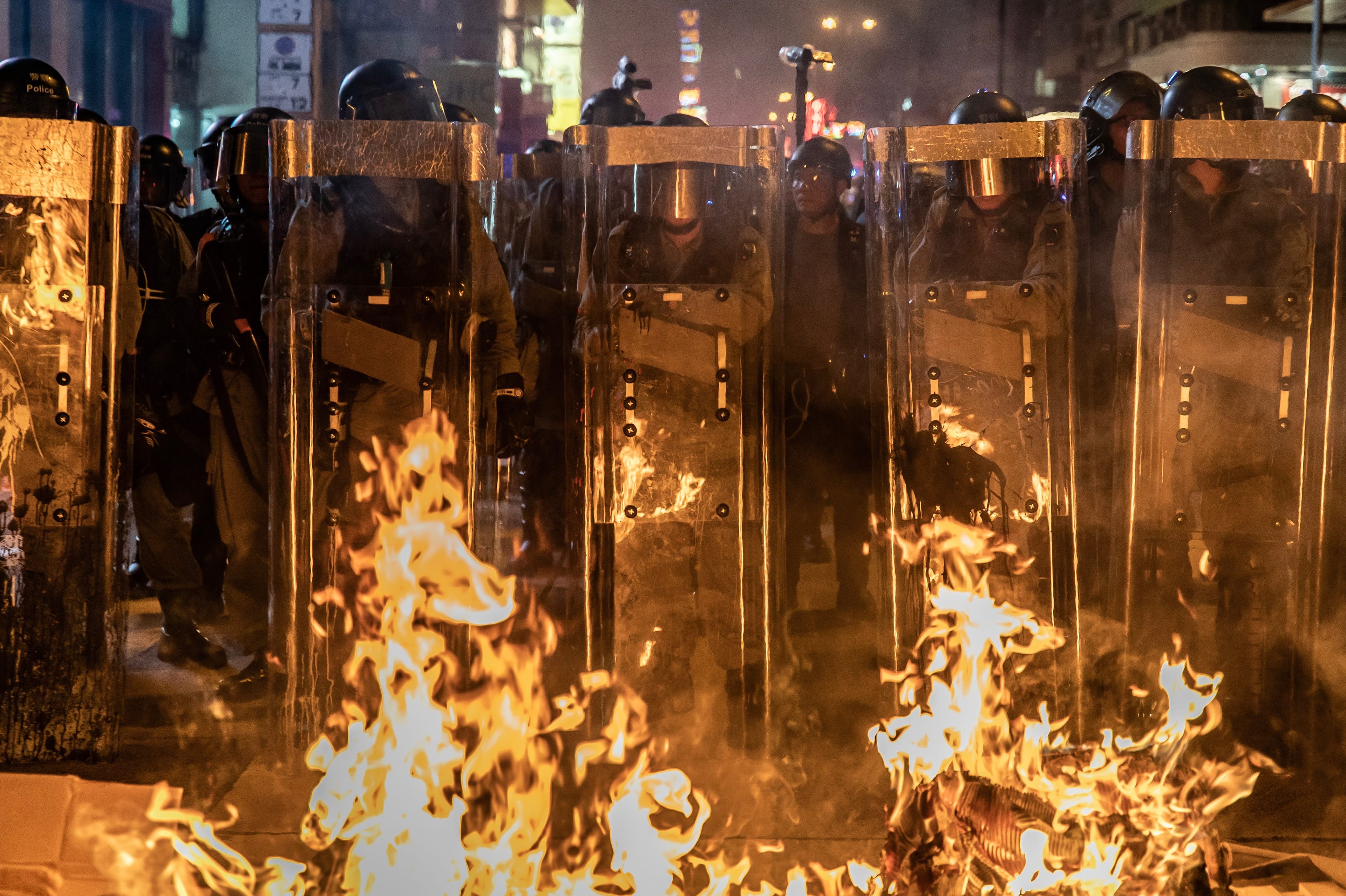 Riot police stand in front a barricade set on fire by protesters after dispersing crowds outside the Mongkok Police Station on September 7, 2019 in Hong Kong, China. (Photo by Anthony Kwan/Getty Images)