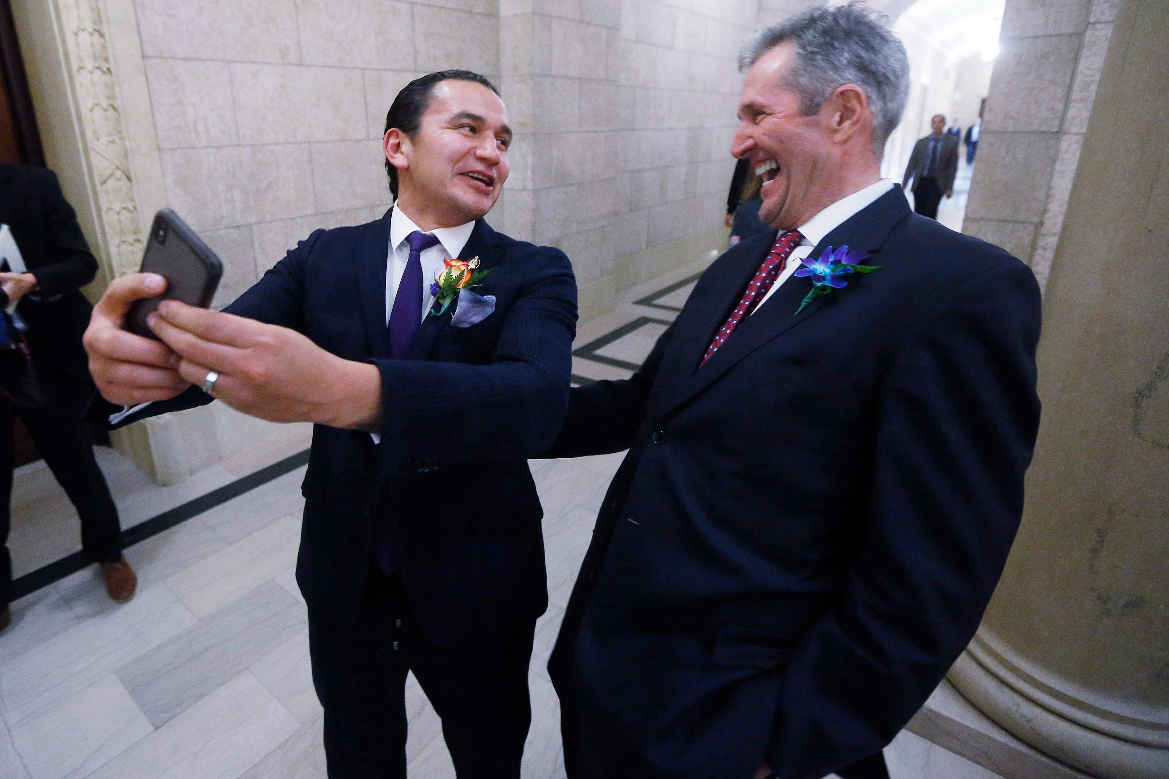 Pallister and Kinew pose for a selfie after the reading of the throne speech at the Manitoba legislature (John Woods/CP)