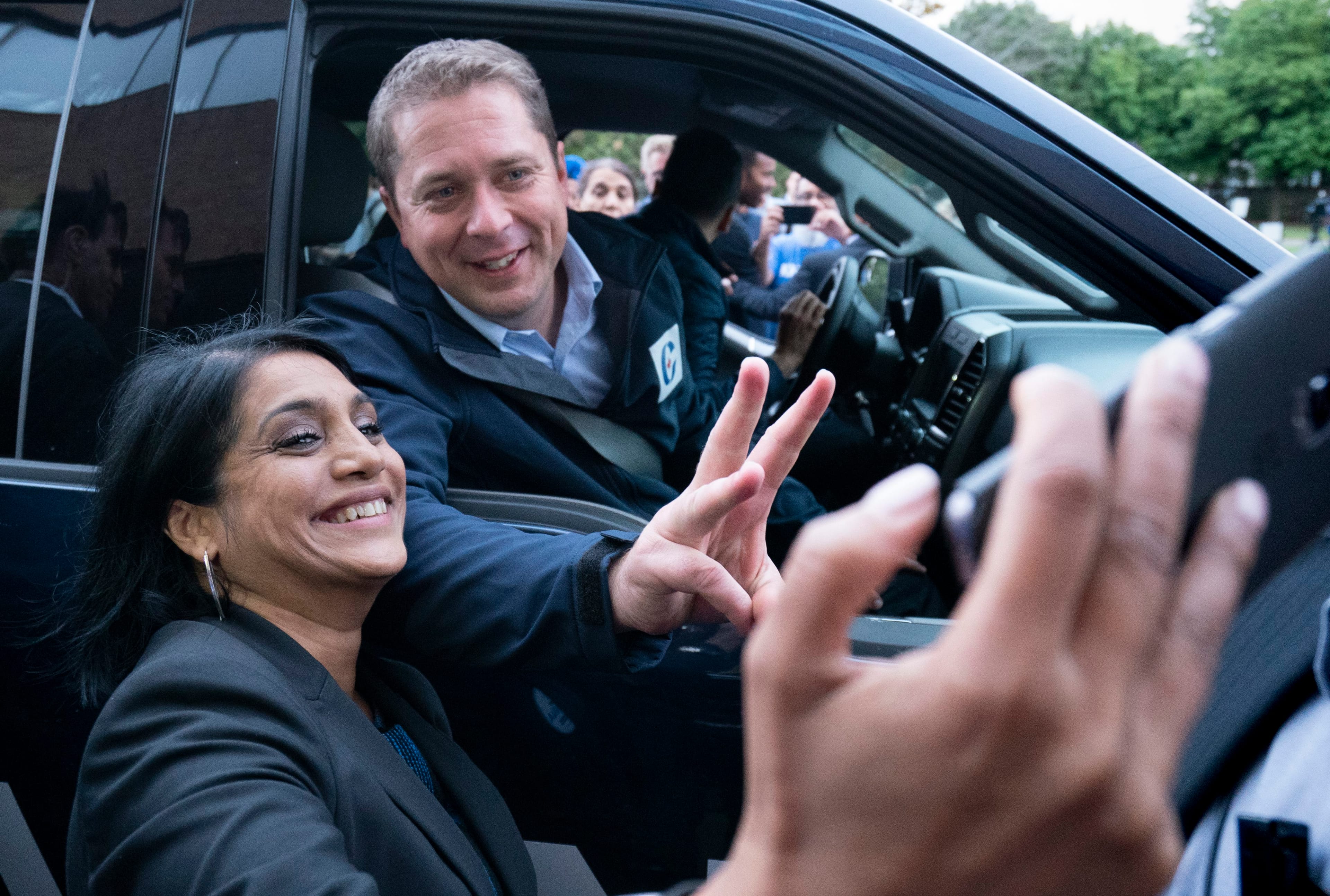 Scheer poses with a supporter during a campaign stop in Brampton, Ont. on Sept. 13, 2019 (THE CANADIAN PRESS/Paul Chiasson)